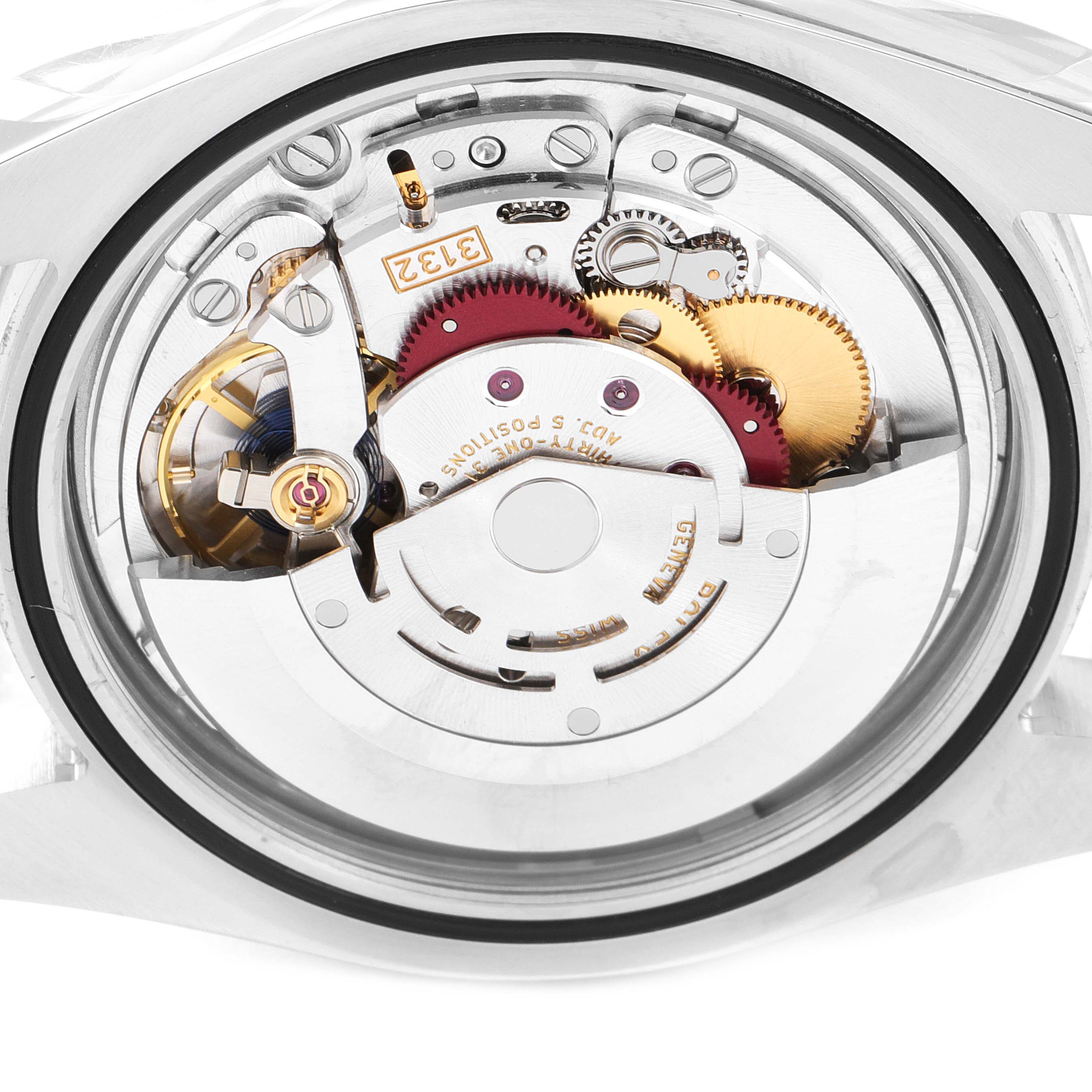The image shows a close-up of the movement of the Rolex Oyster Perpetual 114300 Men's Stainless Steel Silver Dial 114300 Men's Stainless Steel Silver Dial watch from the back.