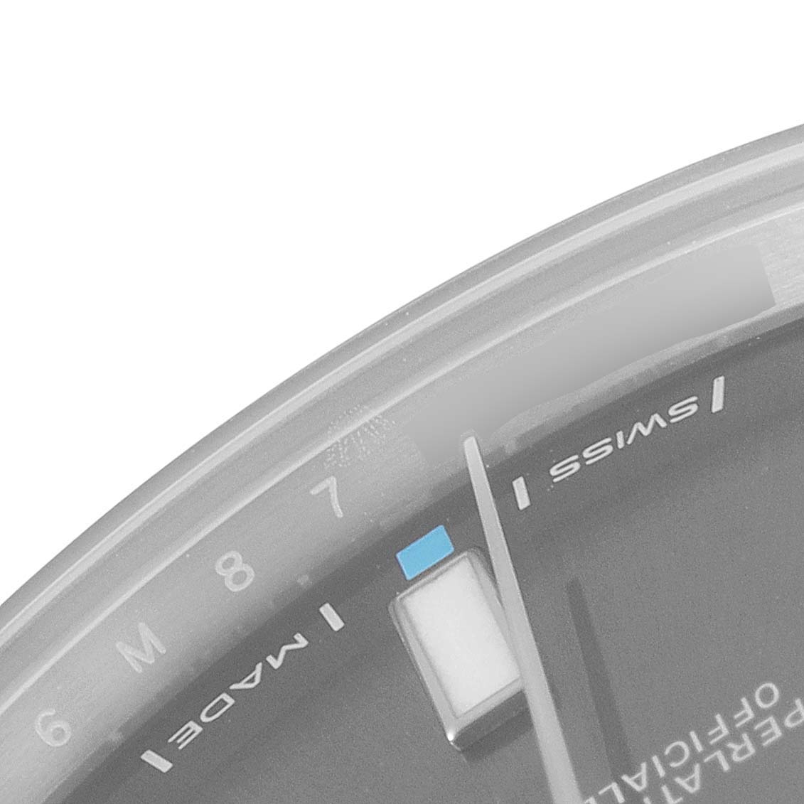 This image shows a close-up of the dial, hands, and 'Swiss Made' text on the Rolex Oyster Perpetual 114300 Men's Stainless Steel Silver Dial 114300 Men's Stainless Steel Silver Dial watch.