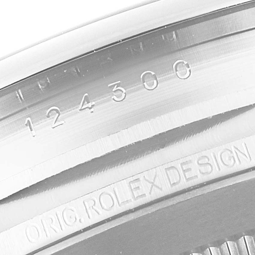 This close-up image shows the model number and "ORIG. ROLEX DESIGN" engraving on the side of the Rolex Oyster Perpetual 124300 Men's Stainless Steel Silver Dial 124300 Men's Stainless Steel Silver Dial watch case.