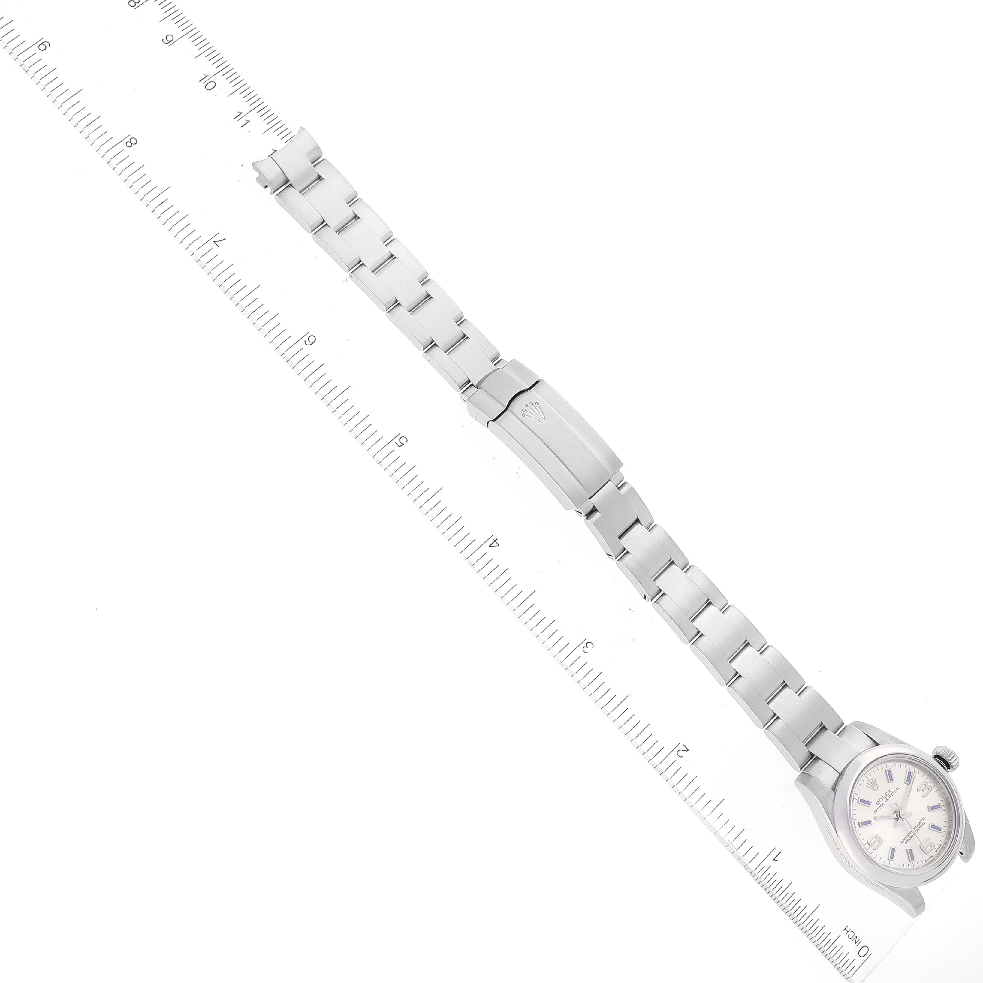 The image shows a Rolex Oyster Perpetual 176200 Women's Stainless Steel Silver Dial 176200 Women's Stainless Steel Silver Dial watch laid flat with its face and stainless steel bracelet visible, beside a ruler for scale.