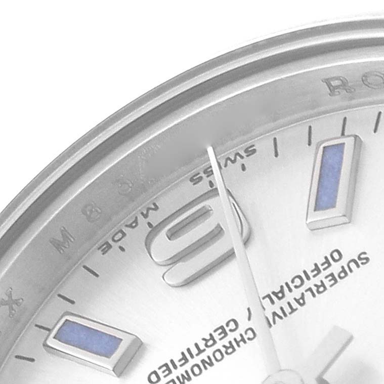 This is a close-up of the dial of a Rolex Oyster Perpetual 176200 Women's Stainless Steel Silver Dial 176200 Women's Stainless Steel Silver Dial watch, showing part of the outer bezel, the "9" marker, and text on the dial.