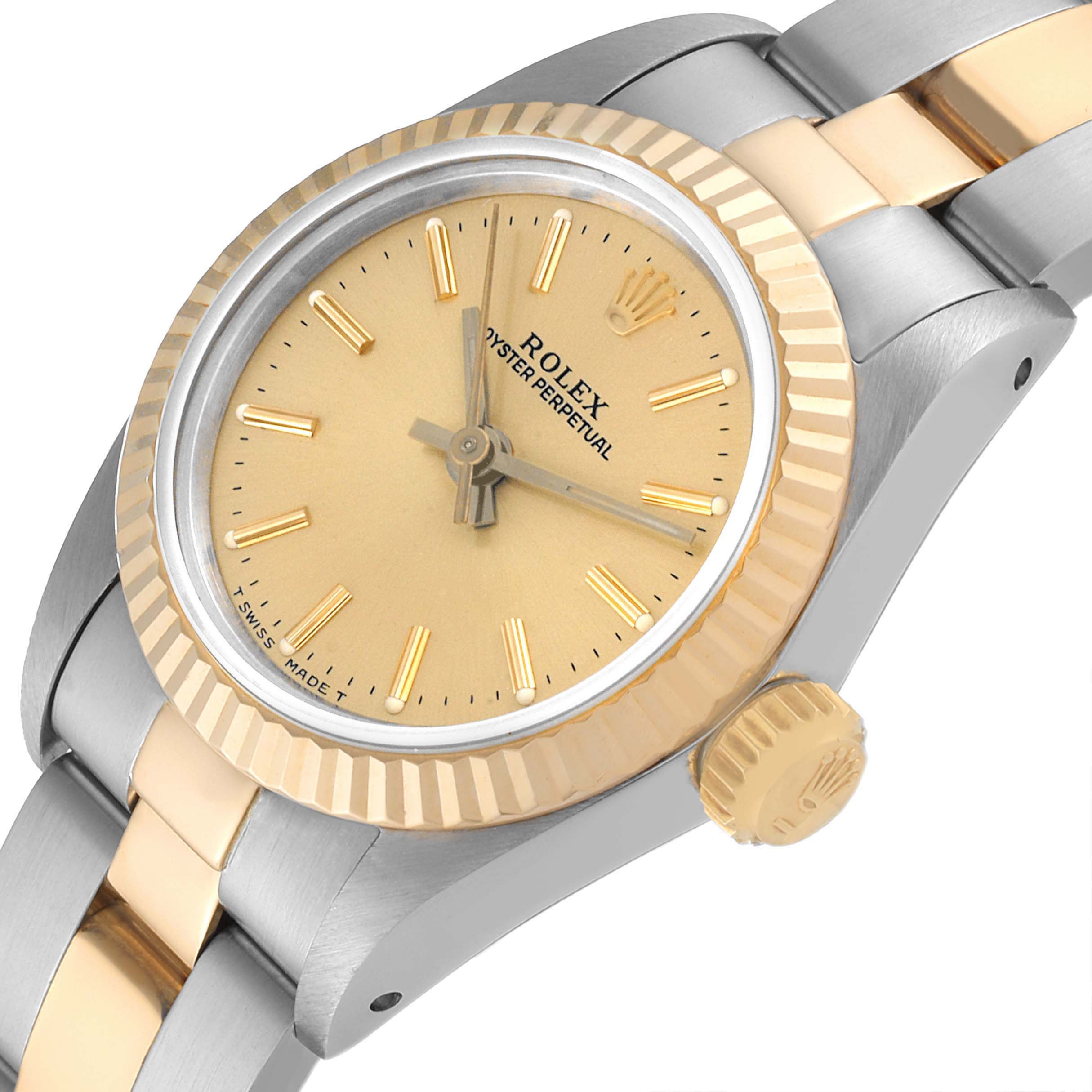 This image shows a close-up angle of the Rolex Oyster Perpetual 67193 Women
s Steel and Gold (two tone) Champagne Dial 67193 Women
s Steel and Gold (two tone) Champagne Dial watch, focusing on the face, bezel, crown, and part of the bracelet.