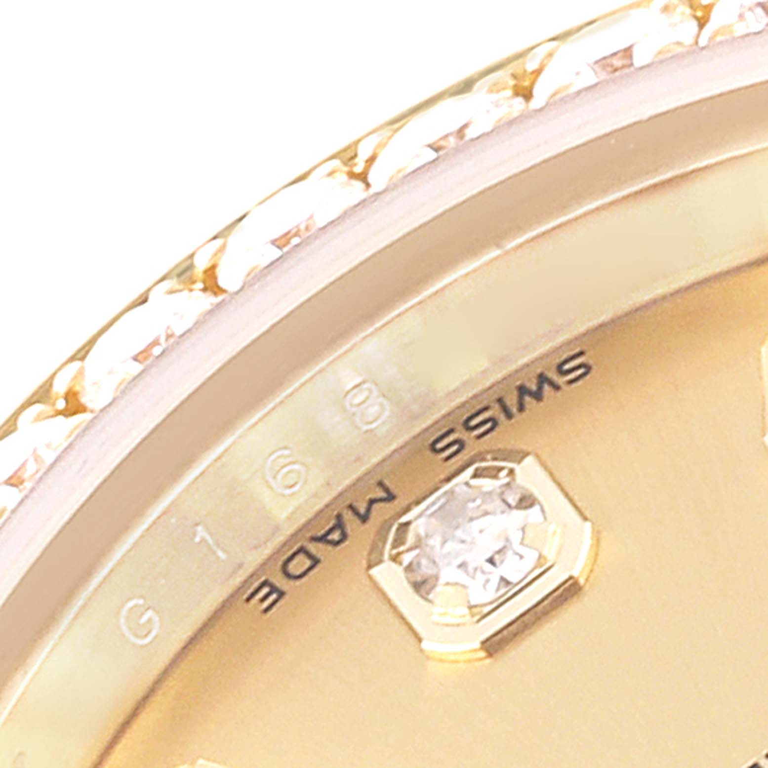 This image shows a close-up of the bezel and part of the dial with a diamond marker on a Rolex President 179158 Women
s Yellow Gold Champagne Dial 179158 Women
s Yellow Gold Champagne Dial model watch.