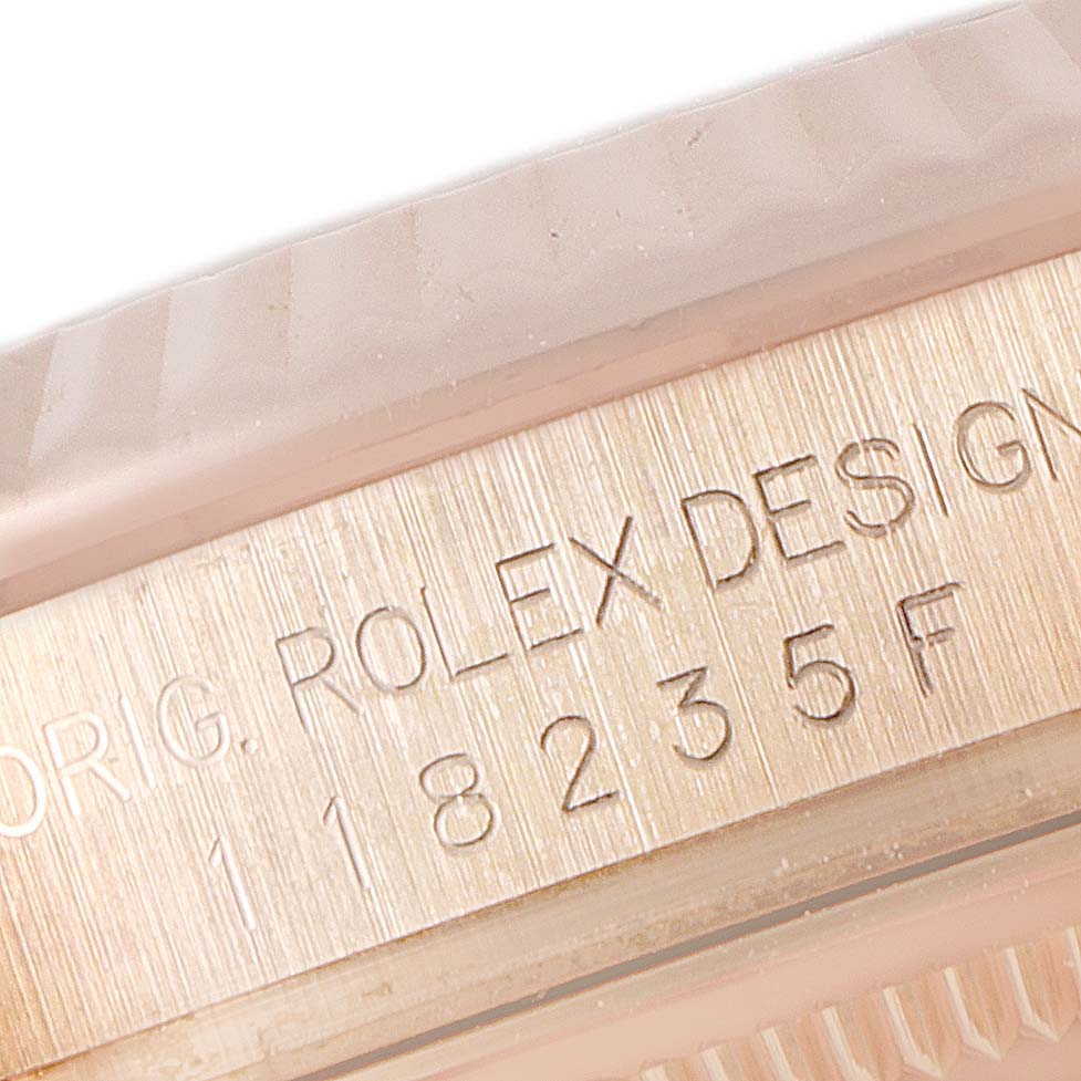 This image shows a close-up of the engraved serial number and design details on a Rolex President 118235 Men's Rose Gold Pink Dial 118235 Men's Rose Gold Pink Dial model.