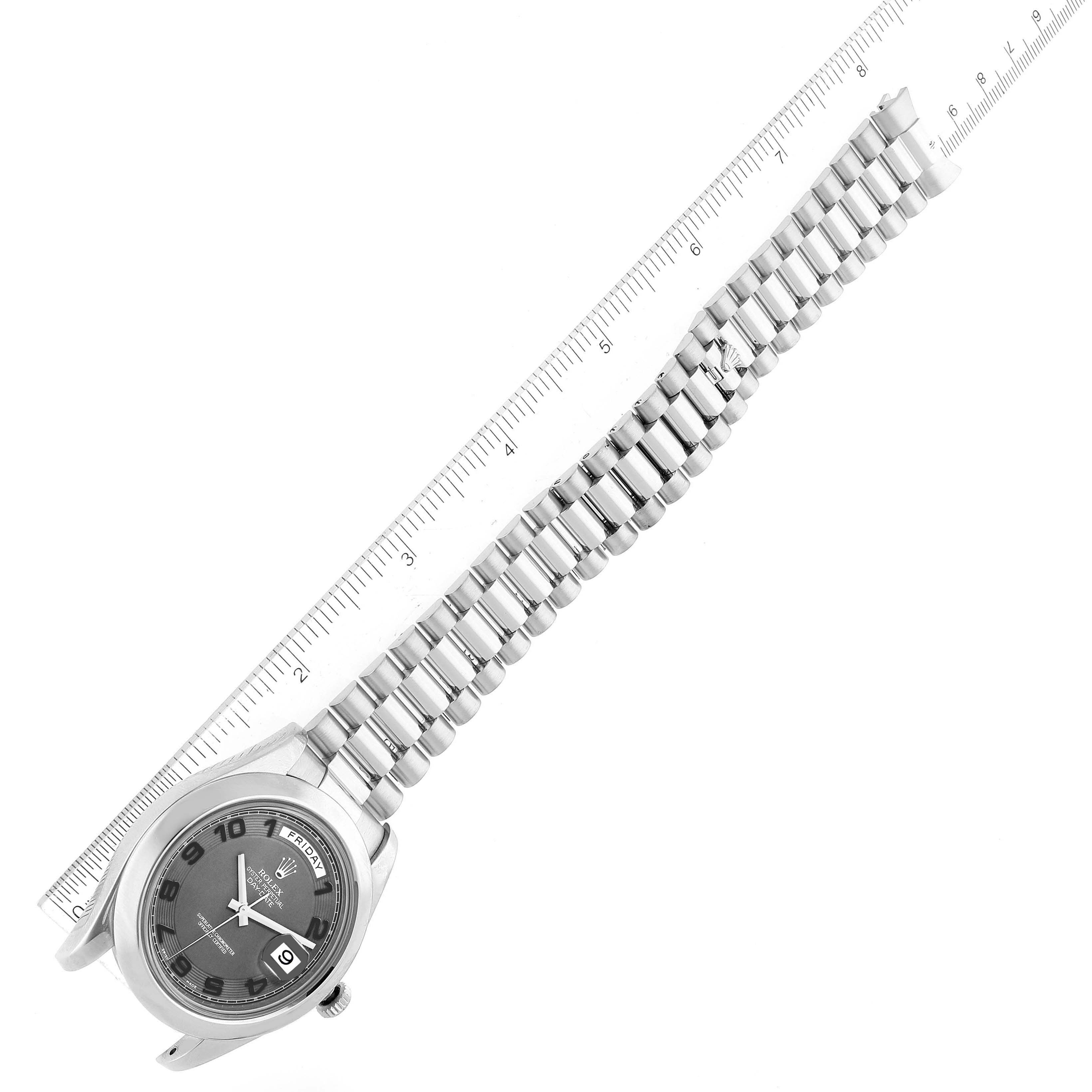 The image shows a Rolex President 218206 Men's Platinum Black Dial 218206 Men's Platinum Black Dial model watch laid flat with its bracelet extended and a ruler beside it for size reference.