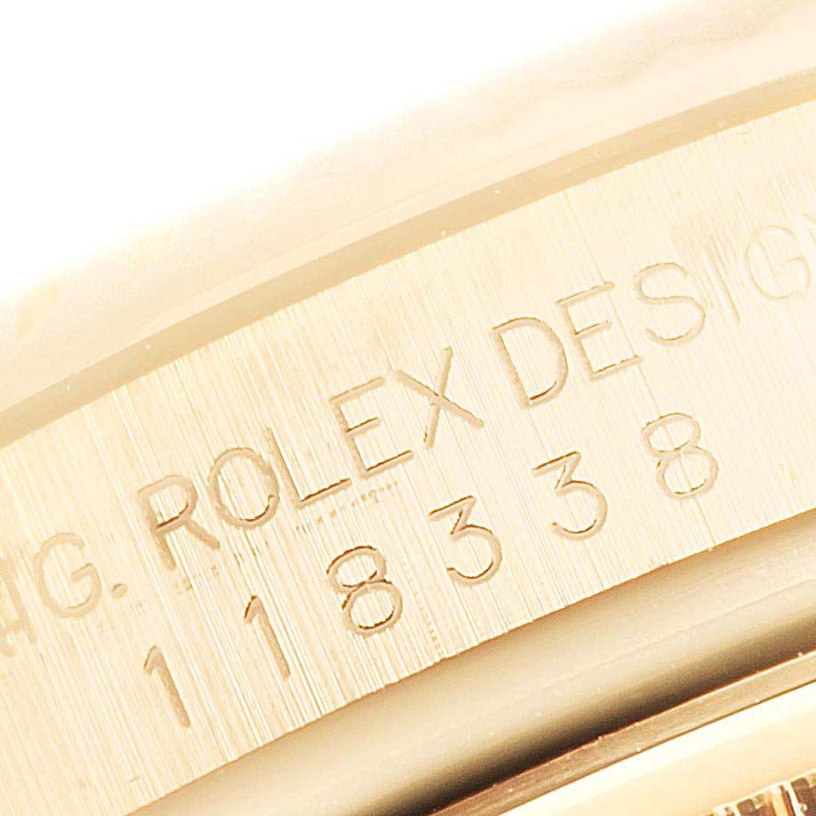 This image shows a close-up of the engraved inscription and serial number on the case of a Rolex President 118338 Men
s Yellow Gold Champagne Dial 118338 Men
s Yellow Gold Champagne Dial model watch.