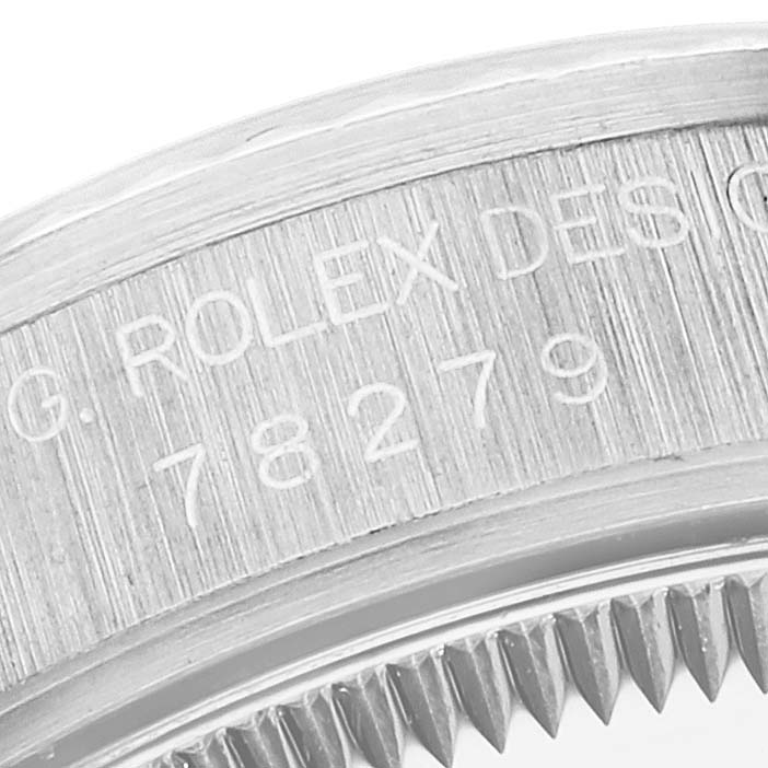 This image shows a close-up of the engraved inner bezel of a Rolex President 78279 Women's White Gold Silver Dial 78279 Women's White Gold Silver Dial model watch.
