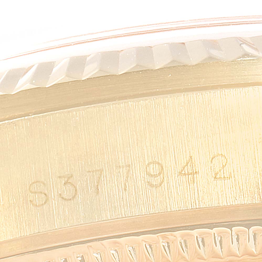 This image shows a close-up of the serial number and part of the bezel on a Rolex President 68278 Women
s Yellow Gold Champagne Dial 68278 Women
s Yellow Gold Champagne Dial model watch.