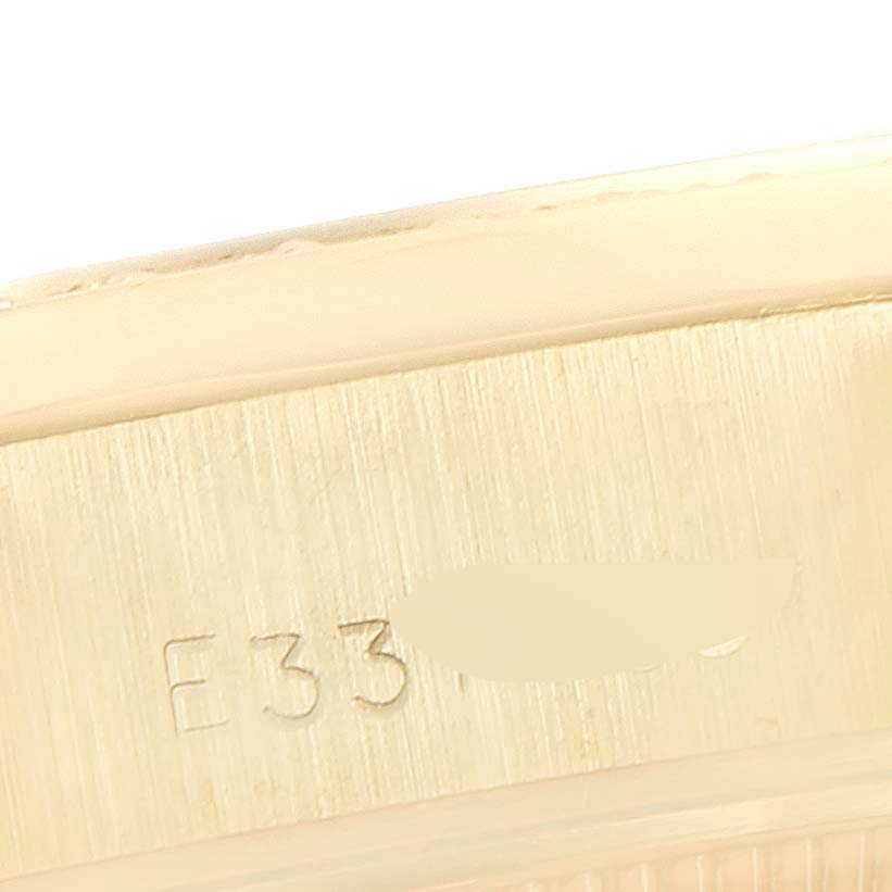 This image shows a close-up of the gold case with engraving on the Rolex President 69138 Women's Yellow Gold Blue Dial 69138 Women's Yellow Gold Blue Dial model watch.