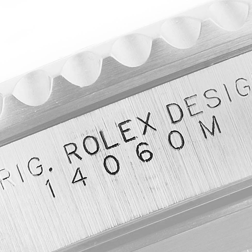 This image shows a close-up view of the engraved side of the case and bezel edge of a Rolex Submariner 14060 Men
s Stainless Steel Black Dial 14060 Men
s Stainless Steel Black Dial model 14060M.