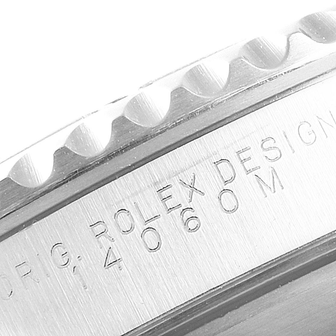 This image shows a close-up of the bezel and engraved text from the side of a Rolex Submariner 14060M Men
s Stainless Steel Black Dial 14060M Men
s Stainless Steel Black Dial watch.