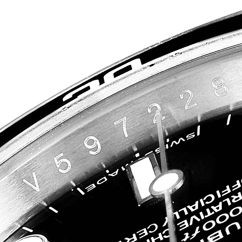 This close-up image of a Rolex Submariner 14060M Men
s Stainless Steel Black Dial 14060M Men
s Stainless Steel Black Dial shows the watch
s bezel and part of the dial, emphasizing the numbers and markings.