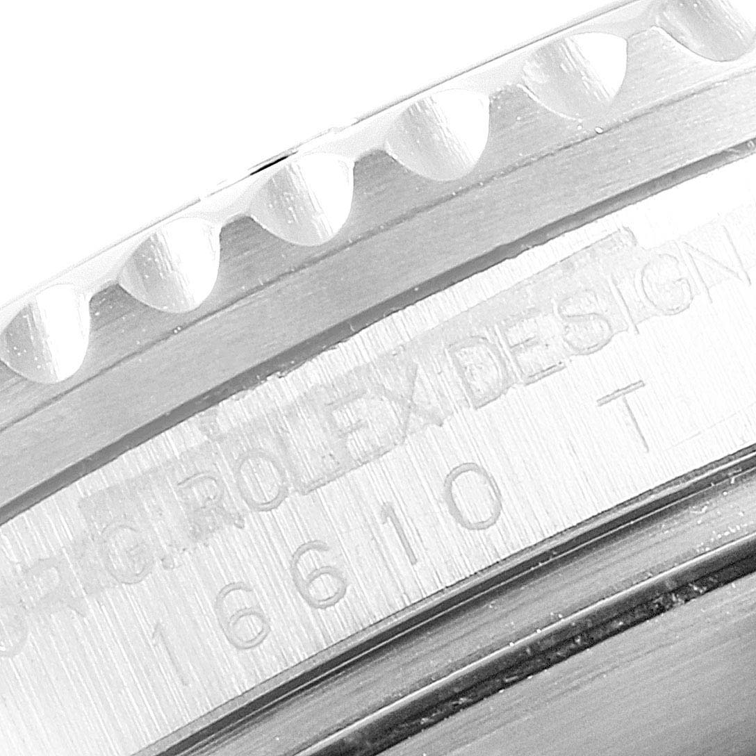 This close-up image shows the engraved serial number and bezel edge of a Rolex Submariner 16610LV Men's Stainless Steel Black Dial 16610LV Men's Stainless Steel Black Dial watch.