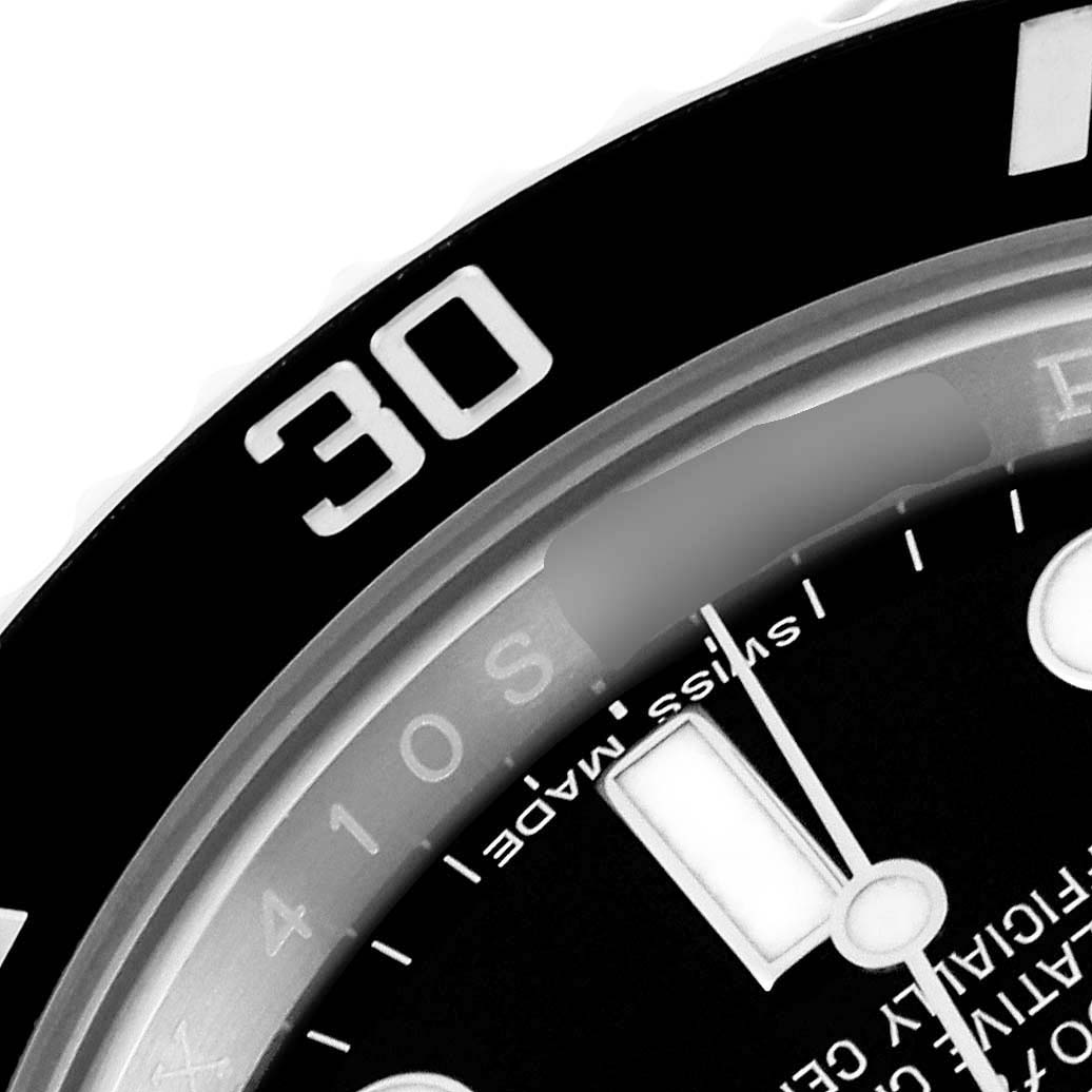 This angled close-up shows part of the bezel and dial of the Rolex Submariner 116610 Men
s Stainless Steel Black Dial 116610 Men
s Stainless Steel Black Dial, highlighting the "30" marking and some text.