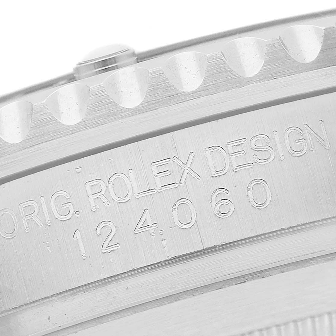 The image shows a close-up of the Rolex Submariner M124060-0001 Men's Stainless Steel Black Dial's model number engraving on the brushed side of the case.