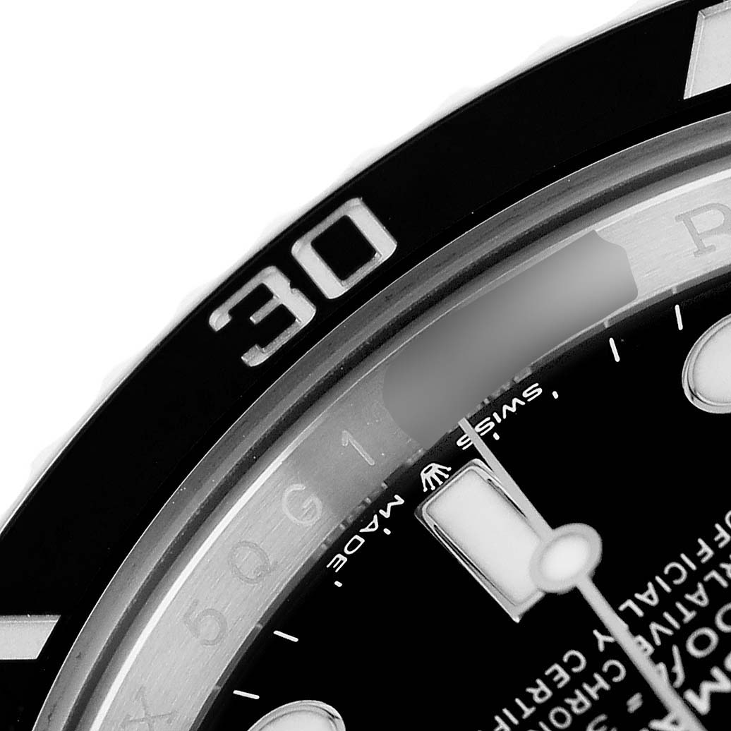 The image shows a close-up of the bezel and dial of a Rolex Submariner M124060-0001 Men's Stainless Steel Black Dial watch, highlighting the 30-minute mark and part of the text.