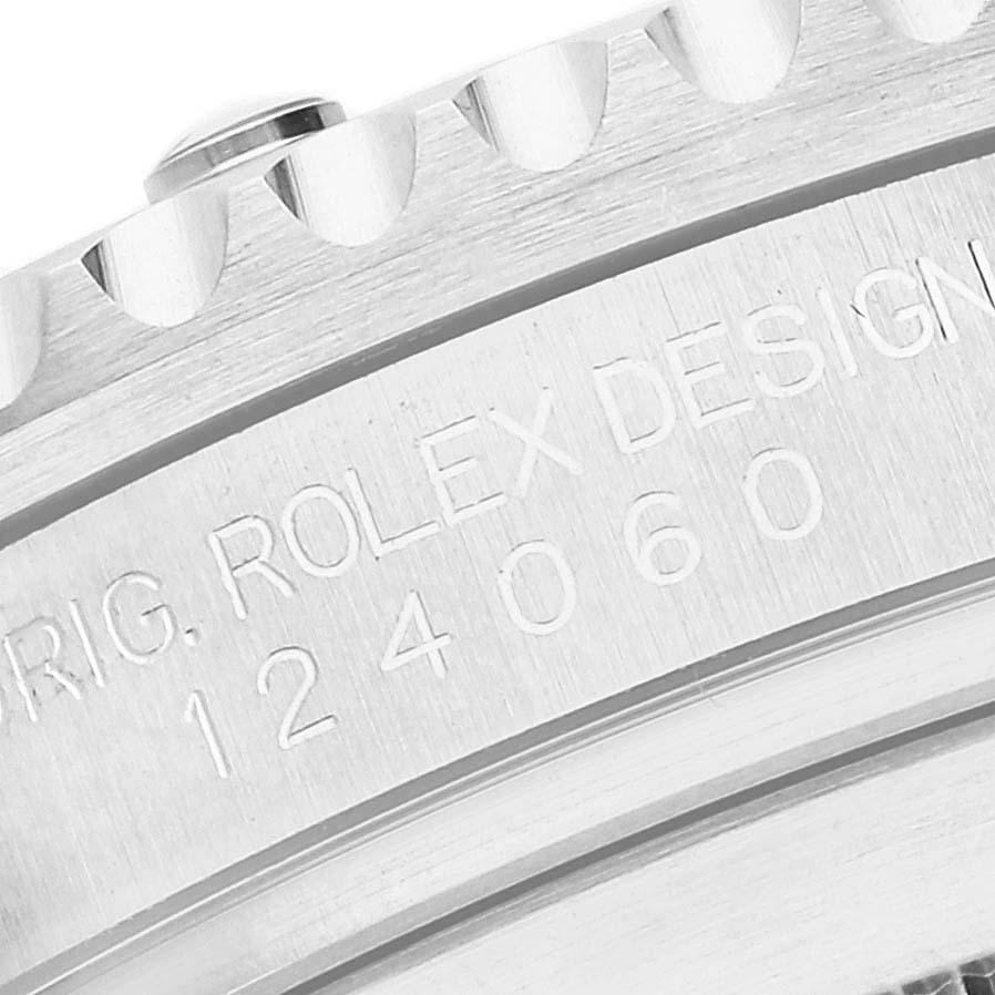 The image shows a close-up of the casing side of a Rolex Submariner 124060 Men's Stainless Steel Black Dial 124060 Men's Stainless Steel Black Dial, highlighting the engraved model and design numbers.