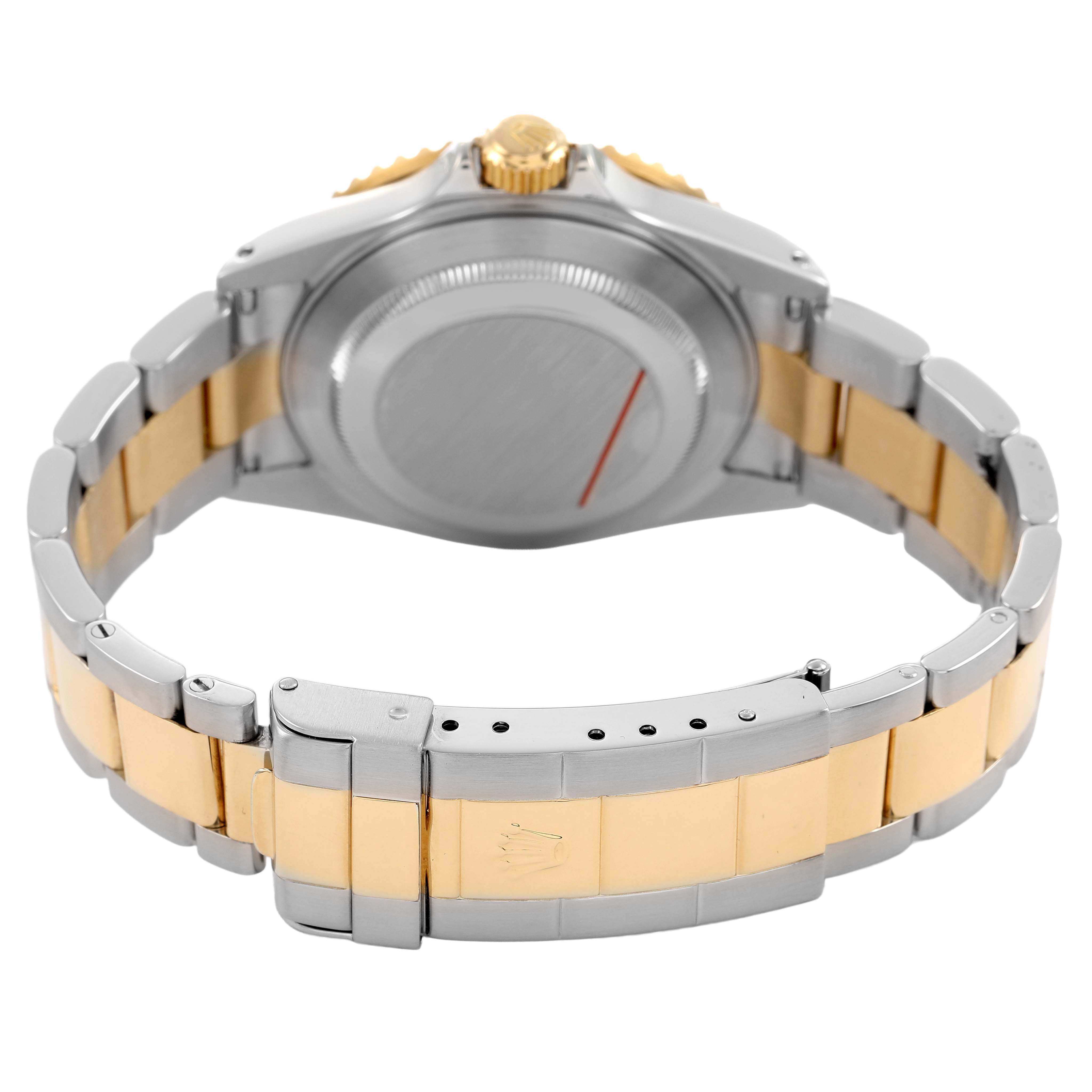 The image shows the back view of a Rolex Submariner 16613 Men's Steel and Gold (two tone) Blue Dial watch, highlighting its clasp, bracelet, and caseback.