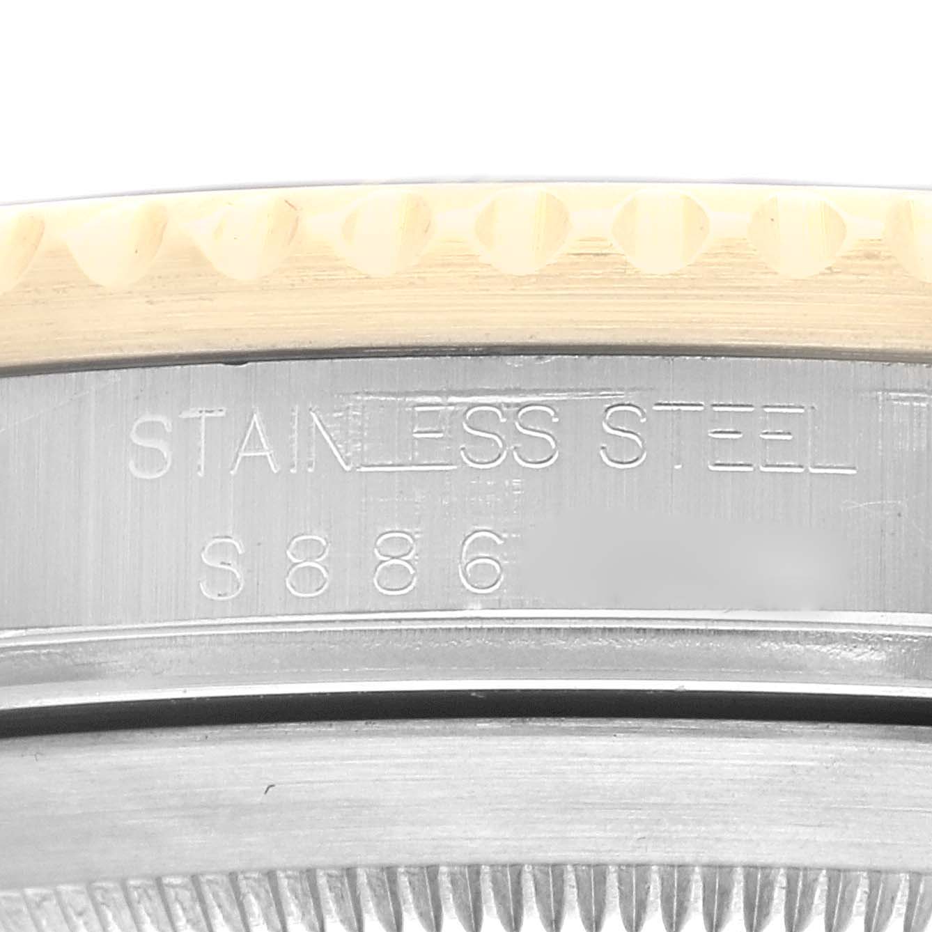 This is a close-up angle of the caseback and part of the bezel of a Rolex Submariner 16613 Men's Steel and Gold (two tone) Grey Dial 16613 Men's Steel and Gold (two tone) Grey Dial, showing the "STAINLESS STEEL" engraving.