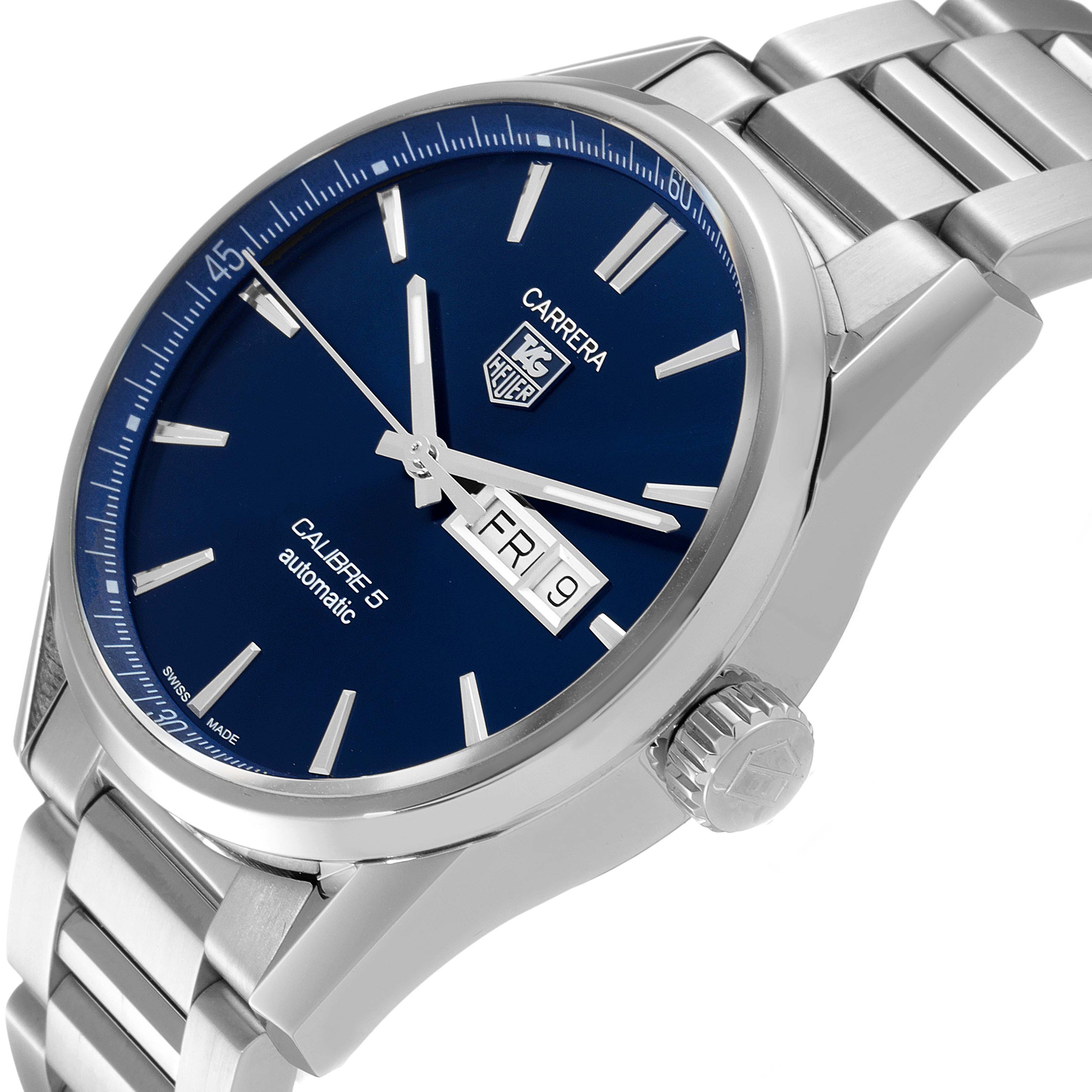 The image shows a Tag Heuer Carrera WAR201E.BA0723 Men
s Stainless Steel Blue Dial WAR201E.BA0723 Men
s Stainless Steel Blue Dial watch with a blue dial, day-date display, and metal bracelet at a tilted angle.