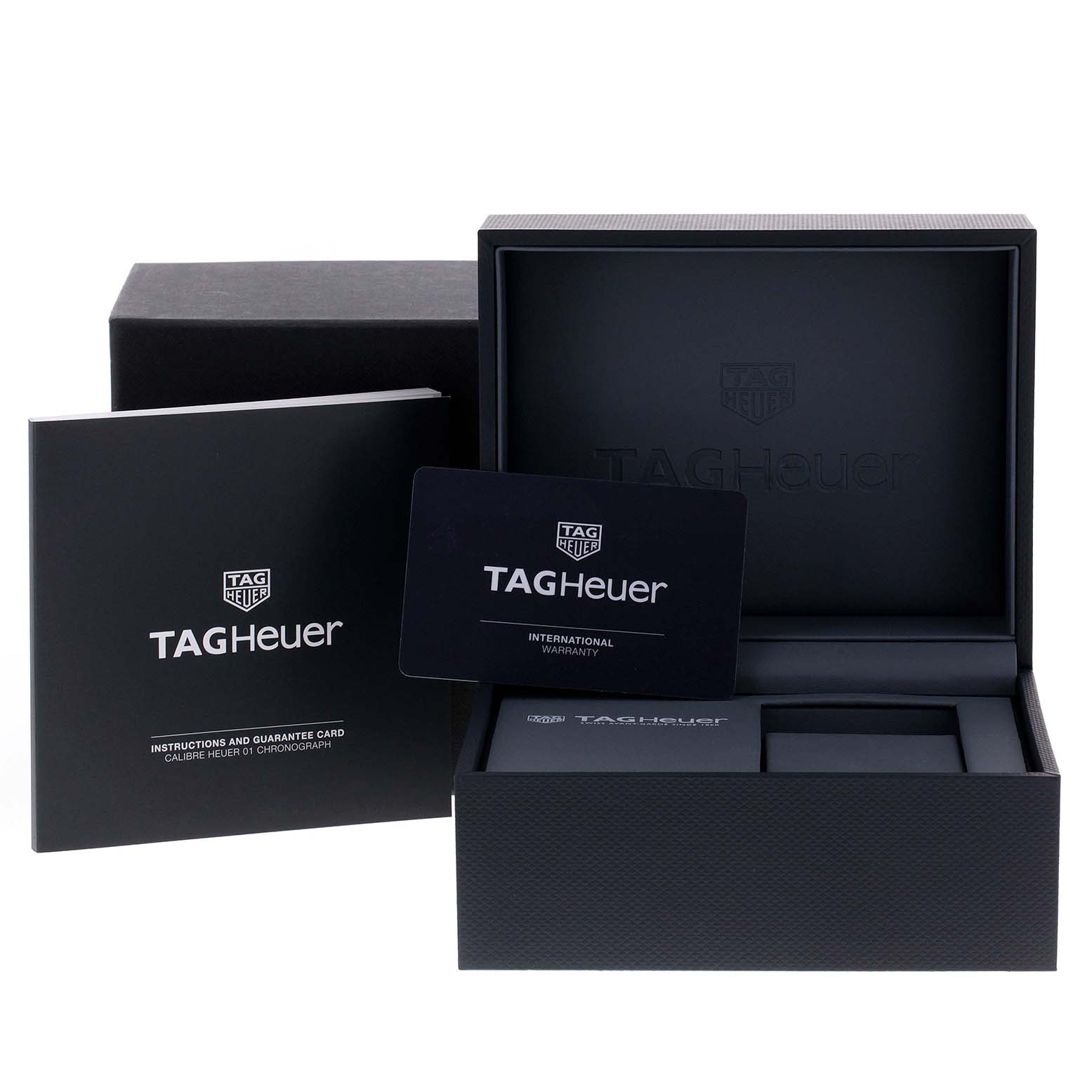 The image shows the packaging and accessories for the Tag Heuer Carrera CAR2A1Z.FT6051 Men
s Stainless Steel Black Dial CAR2A1Z.FT6051 Men
s Stainless Steel Black Dial model, including the box, manual, and warranty card.