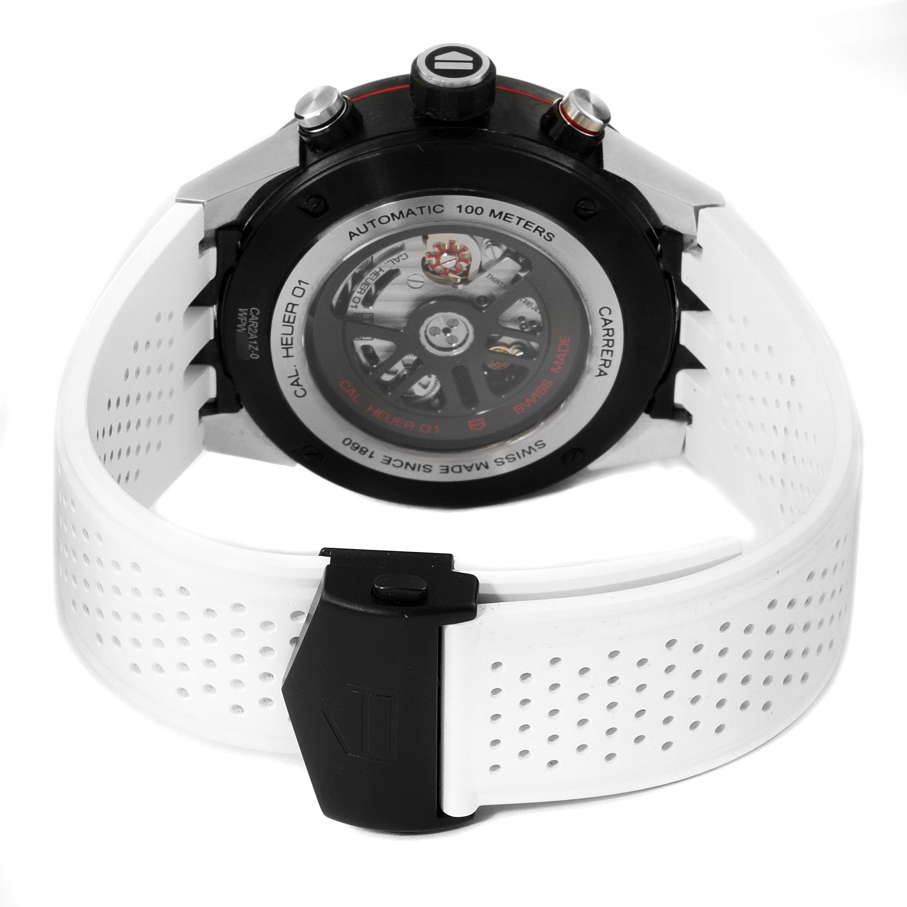 The image shows the back view of a Tag Heuer Carrera CAR2A1Z.FT6051 Men
s Stainless Steel Black Dial CAR2A1Z.FT6051 Men
s Stainless Steel Black Dial watch, highlighting its automatic movement, perforated white strap, and clasp.