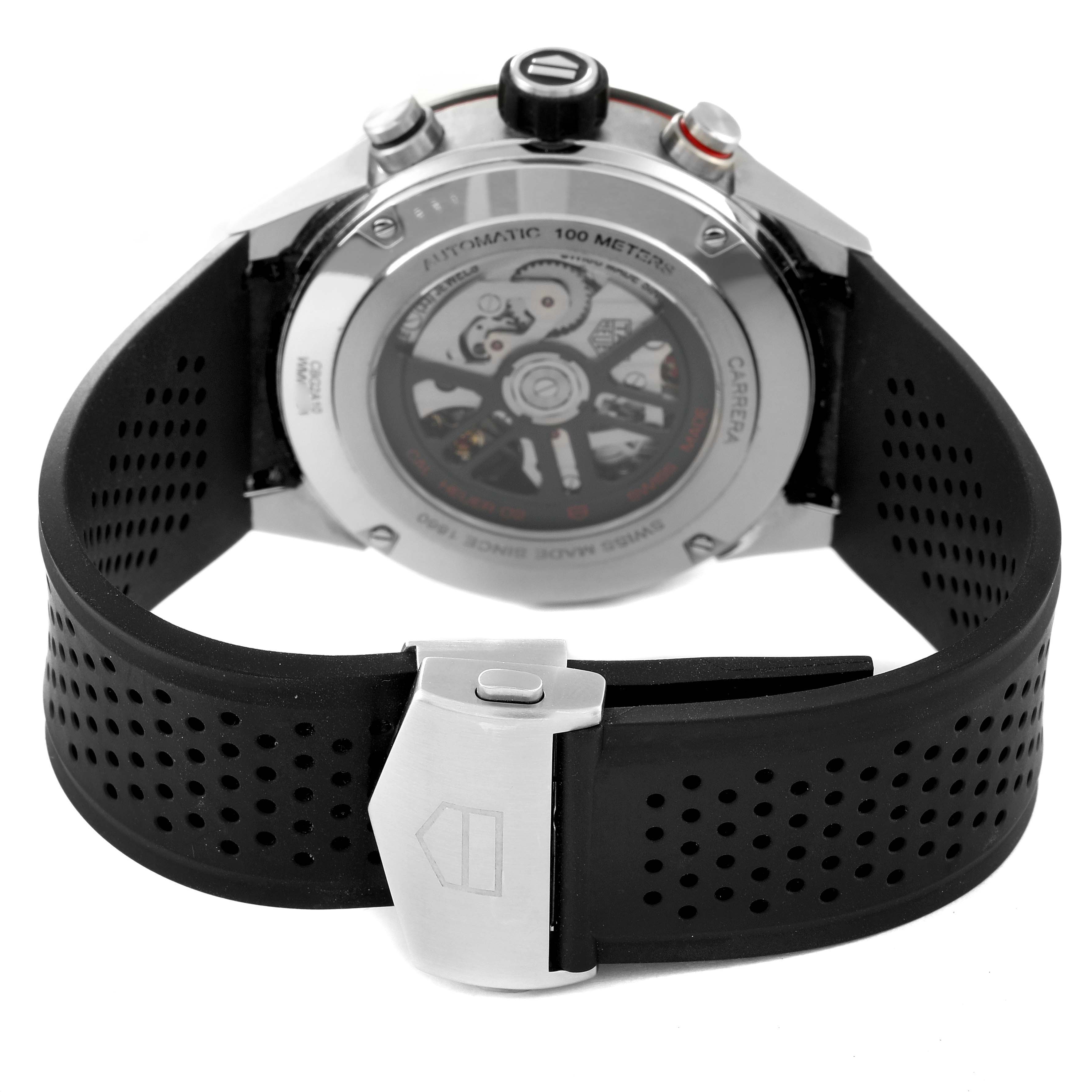 The image shows the back view of a Tag Heuer Carrera CBG2A10.BA0654 Men's Stainless Steel Black Dial CBG2A10.BA0654 Men's Stainless Steel Black Dial watch, highlighting its case back and black perforated strap with a clasp.