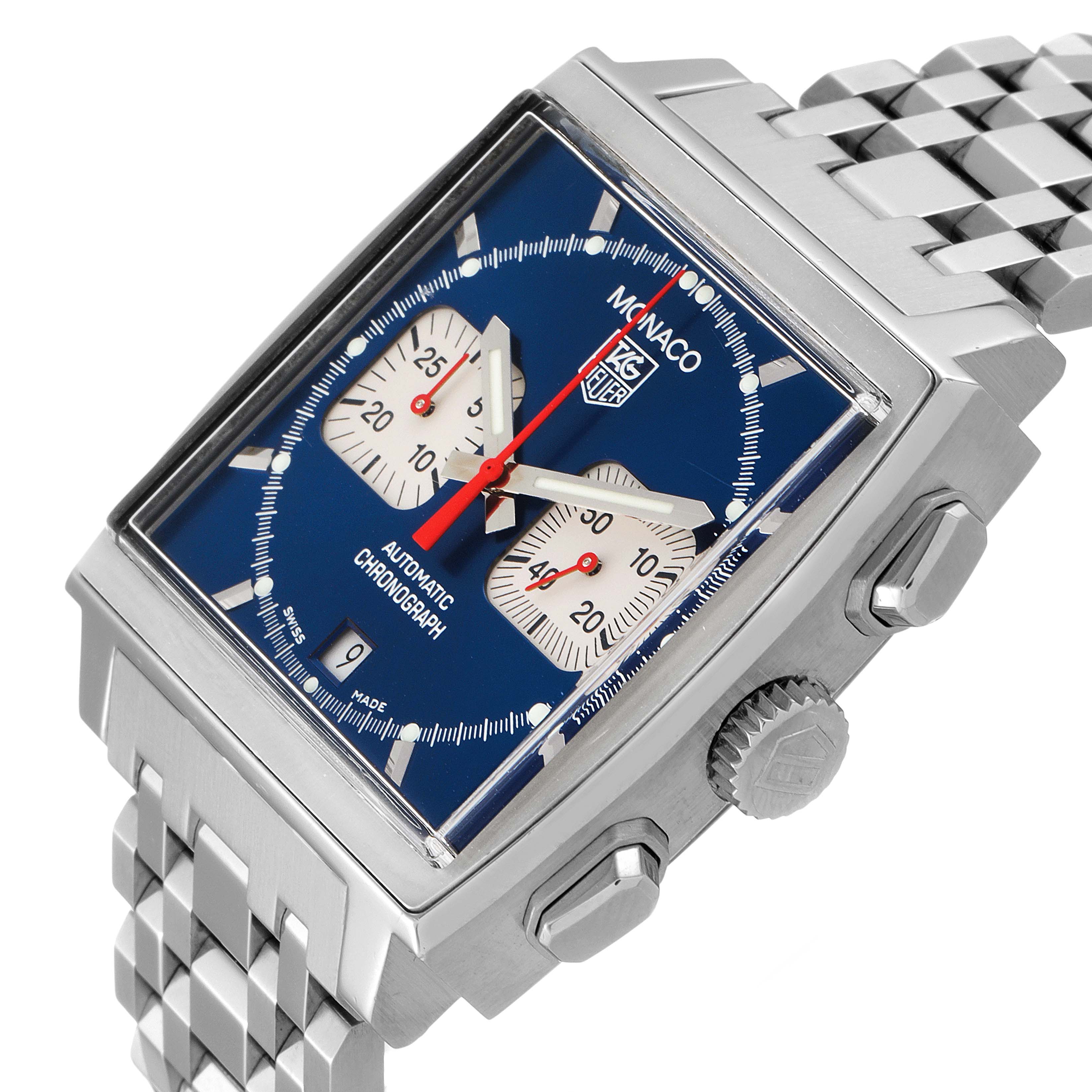 The Tag Heuer Monaco CW2113.BA0780 Men's Stainless Steel Blue Dial CW2113.BA0780 Men's Stainless Steel Blue Dial watch is shown from a slight top-side angle, displaying its blue dial, square case, chronograph subdials, and metal bracelet.