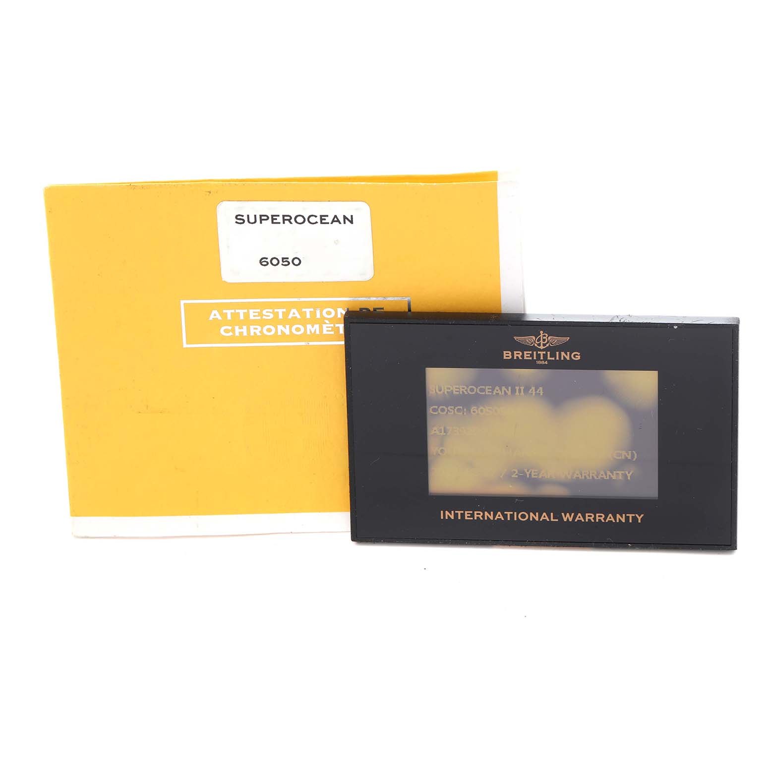 The image shows a Breitling Superocean A17392 Men
s Stainless Steel Black Dial A17392 Men
s Stainless Steel Black Dial warranty card and chronometer certificate from a front angle.