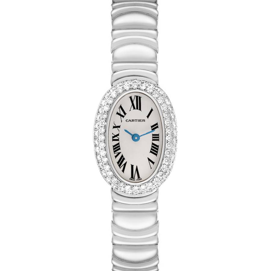 The Cartier Baignoire watch is shown from a top-down perspective, highlighting its oval face, diamond bezel, and metal bracelet.