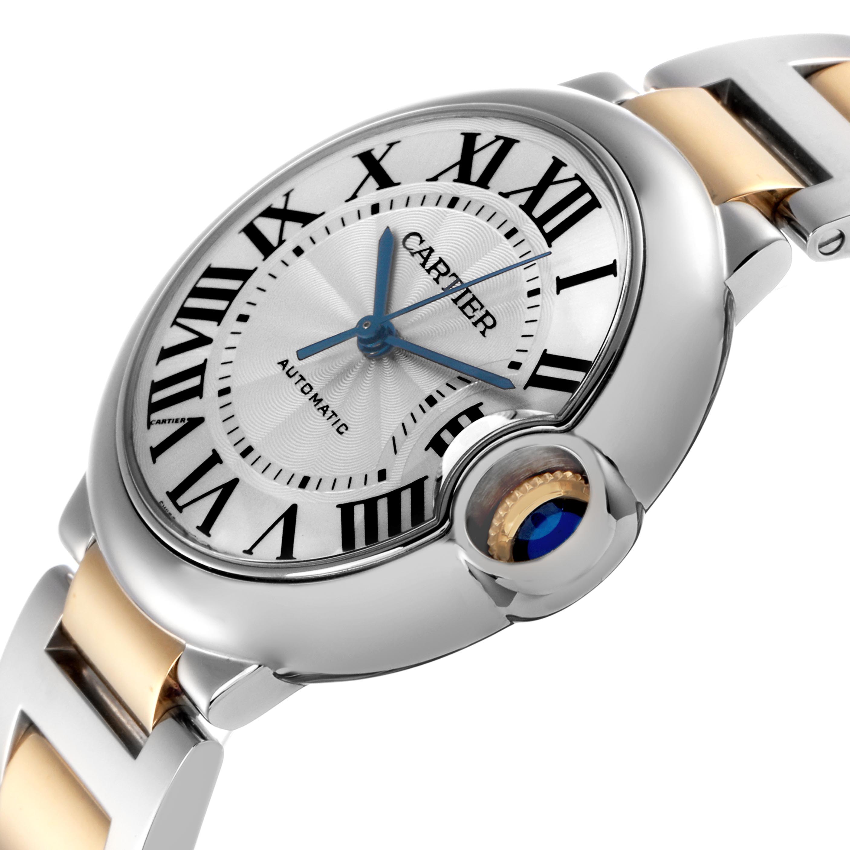 The Cartier Ballon Bleu W2BB0012 Women
s Steel and Gold (two tone) Silver Dial W2BB0012 Women
s Steel and Gold (two tone) Silver Dial watch is shown at a slight angle highlighting its white dial, blue sword-shaped hands, and fluted crown with blue cabochon.