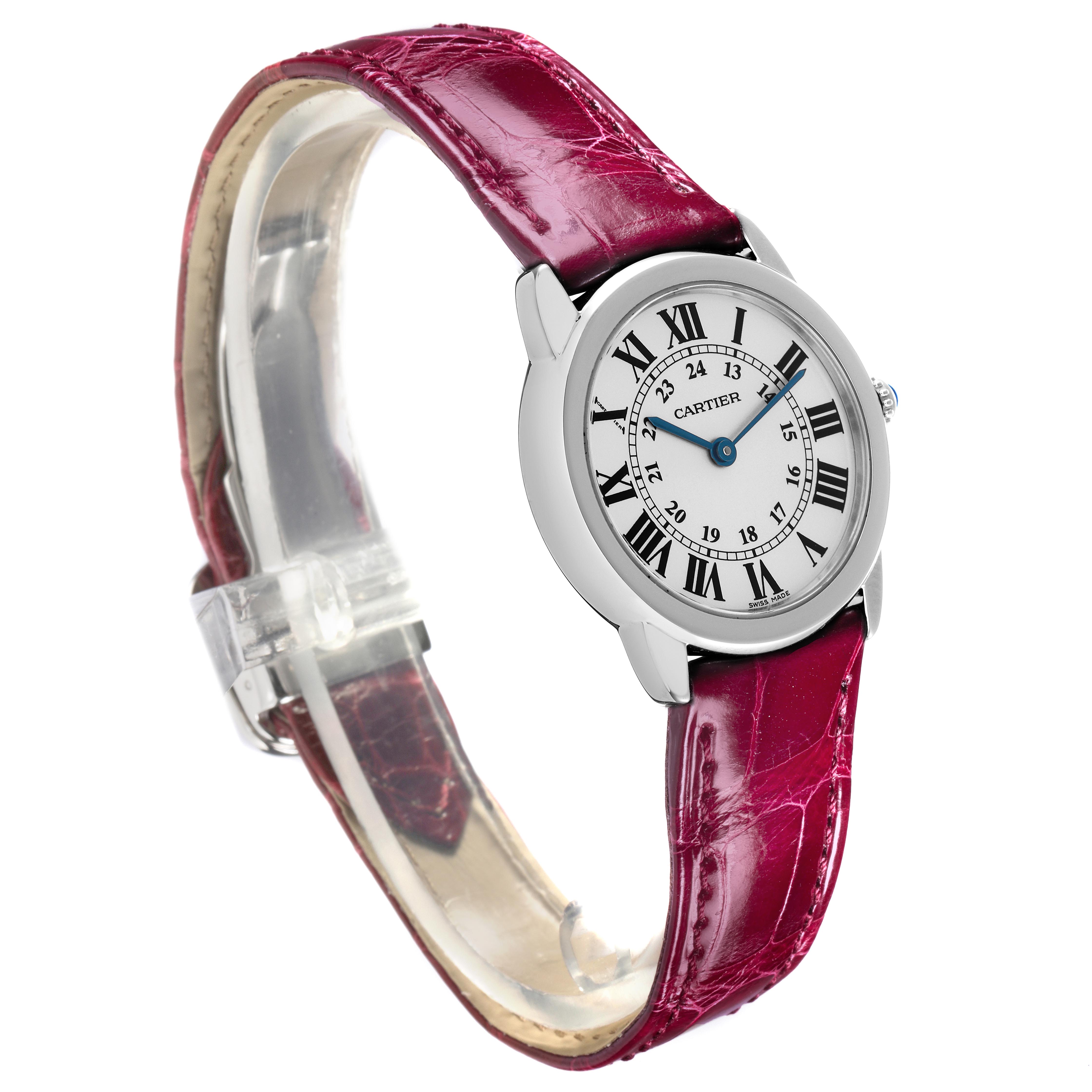 The Cartier Ronde W6700155 Women
s Stainless Steel Silver Dial W6700155 Women
s Stainless Steel Silver Dial watch is shown at a slight angle, displaying its face, Roman numerals, and red leather strap.