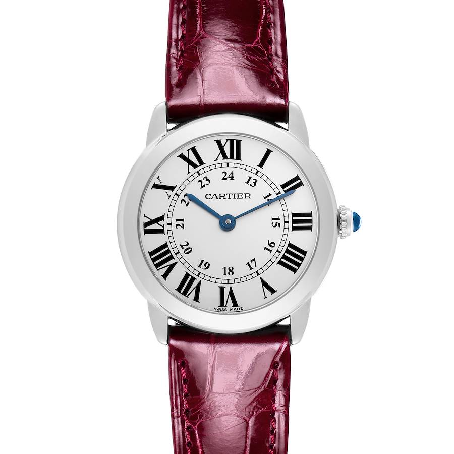 The Cartier Ronde watch is shown from a front angle, displaying the face, Roman numerals, blue hands, and a red leather strap.