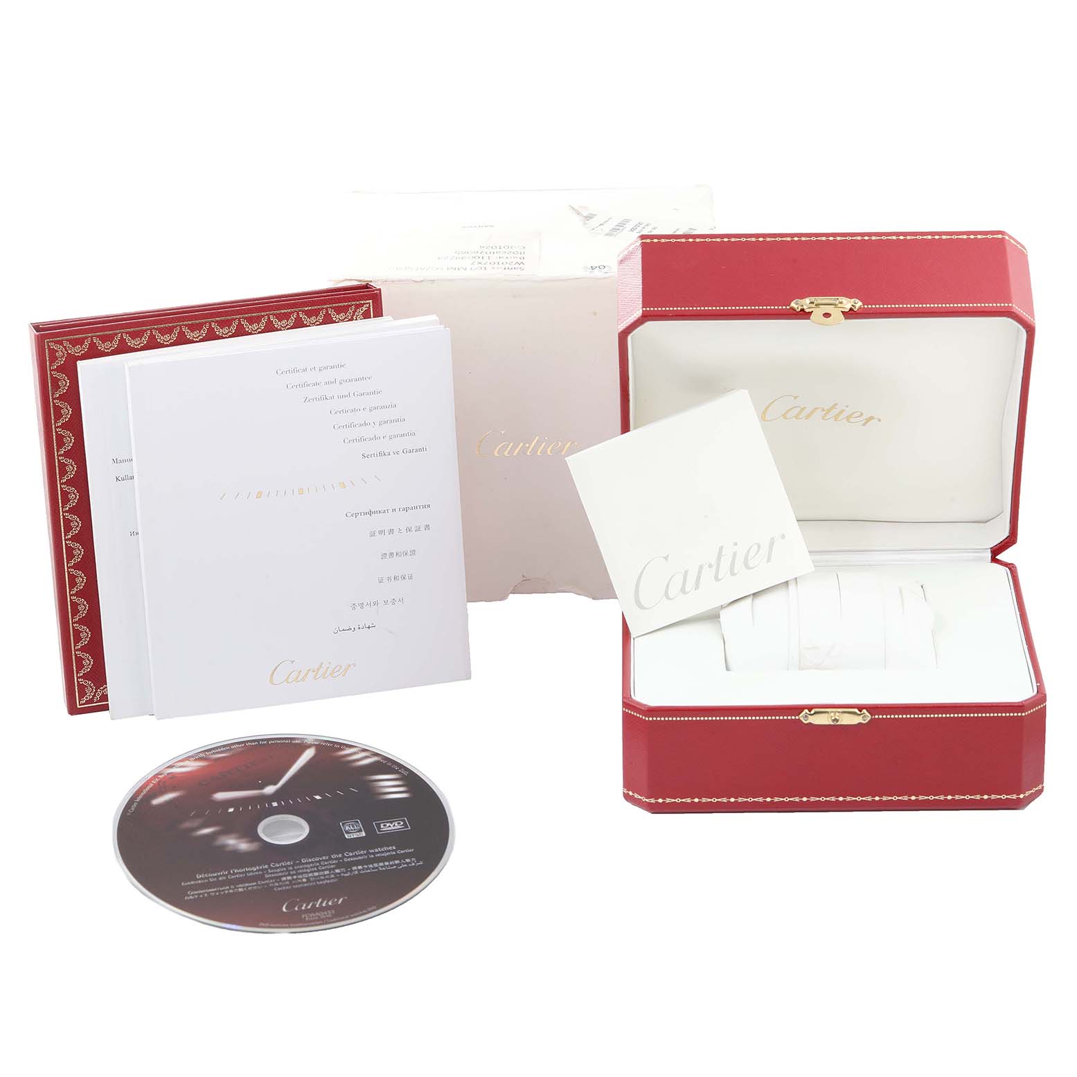 The image shows accessories and packaging for the Santos model by Cartier, including a box, booklets, and a CD.
