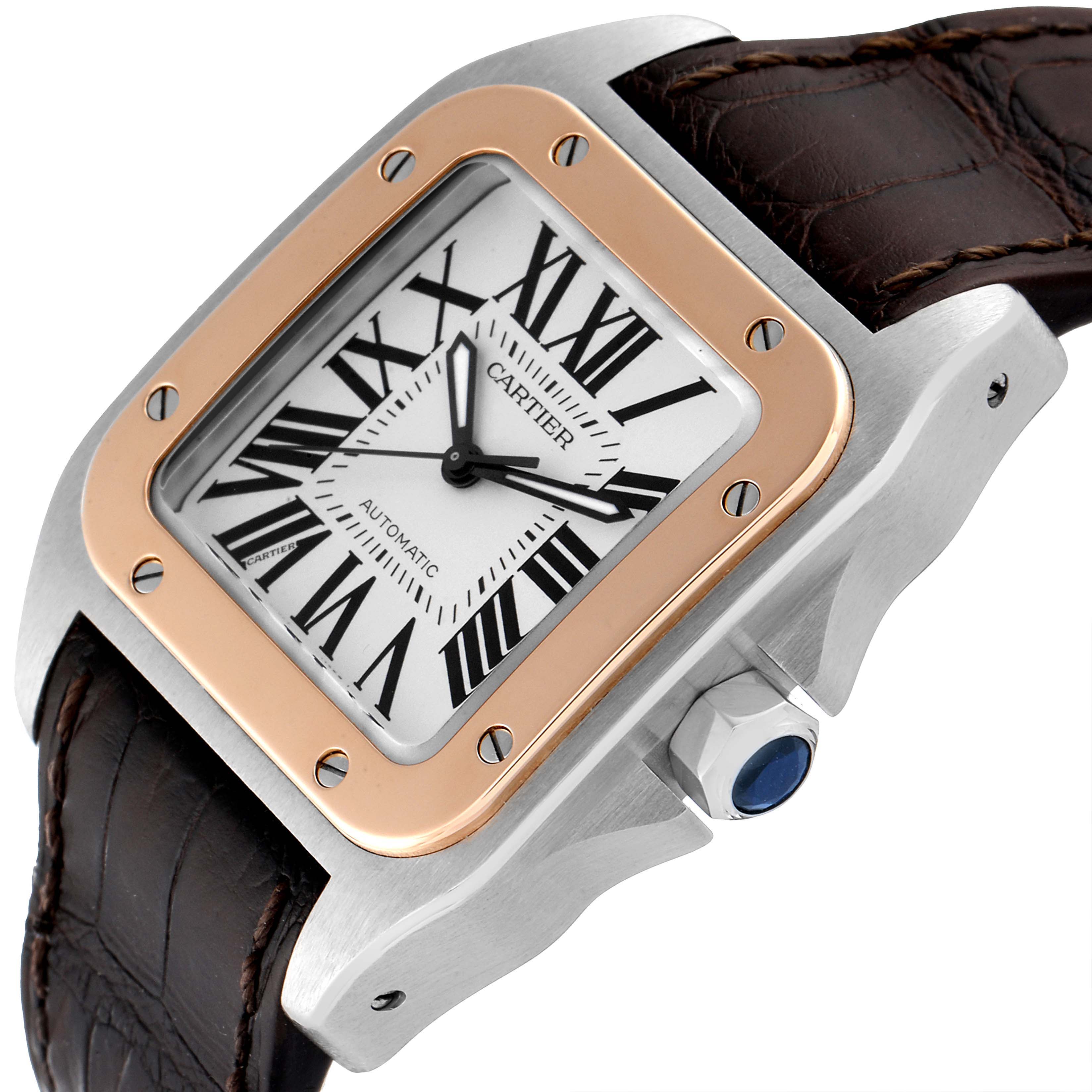 The image shows a close-up of the Cartier Santos W20106X8 Men's Steel and Gold (two tone) Silver Dial W20106X8 Men's Steel and Gold (two tone) Silver Dial watch's face, bezel, crown, and leather strap at an angle.