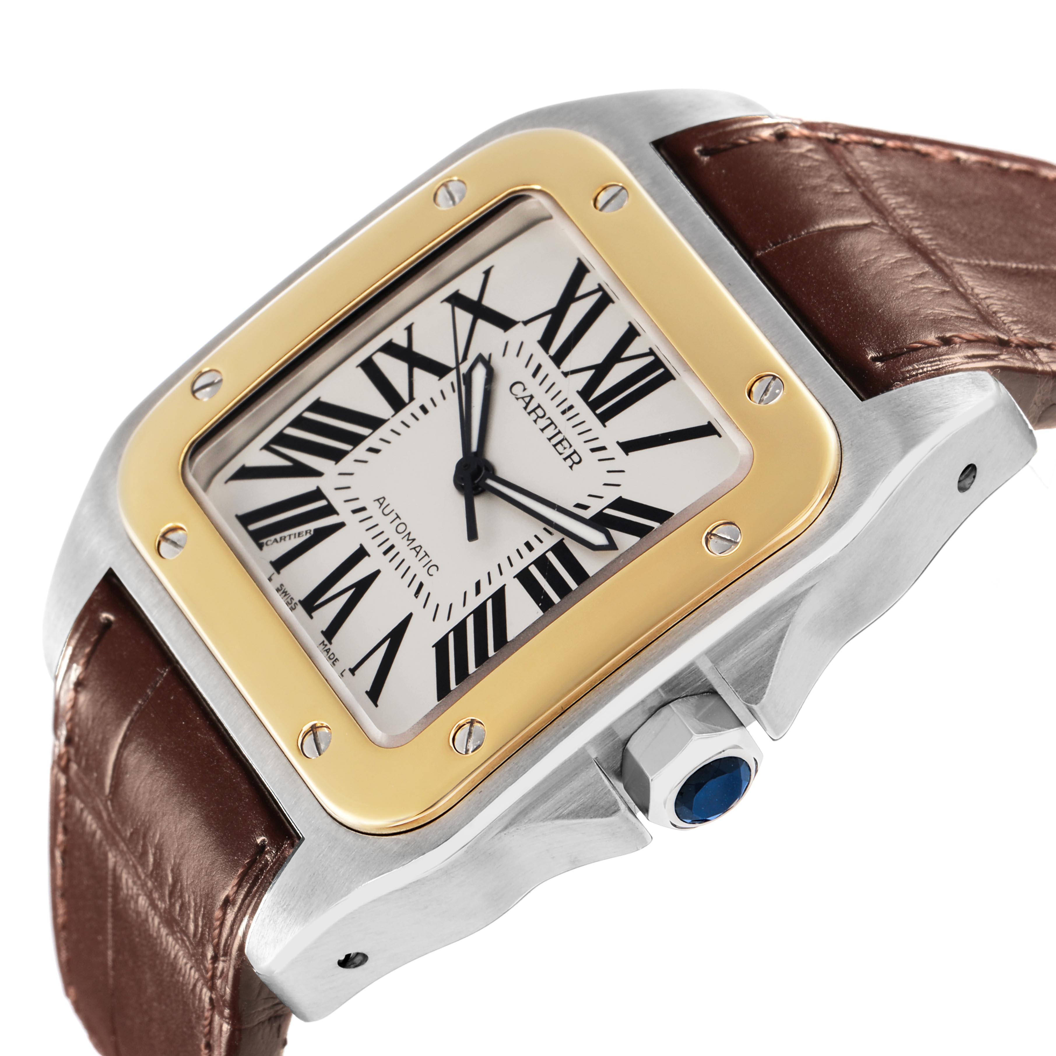 The Cartier Santos W20072X7 Men's Steel and Gold (two tone) Silver Dial W20072X7 Men's Steel and Gold (two tone) Silver Dial watch is shown at an angled close-up, highlighting the dial, bezel, crown, and leather strap.