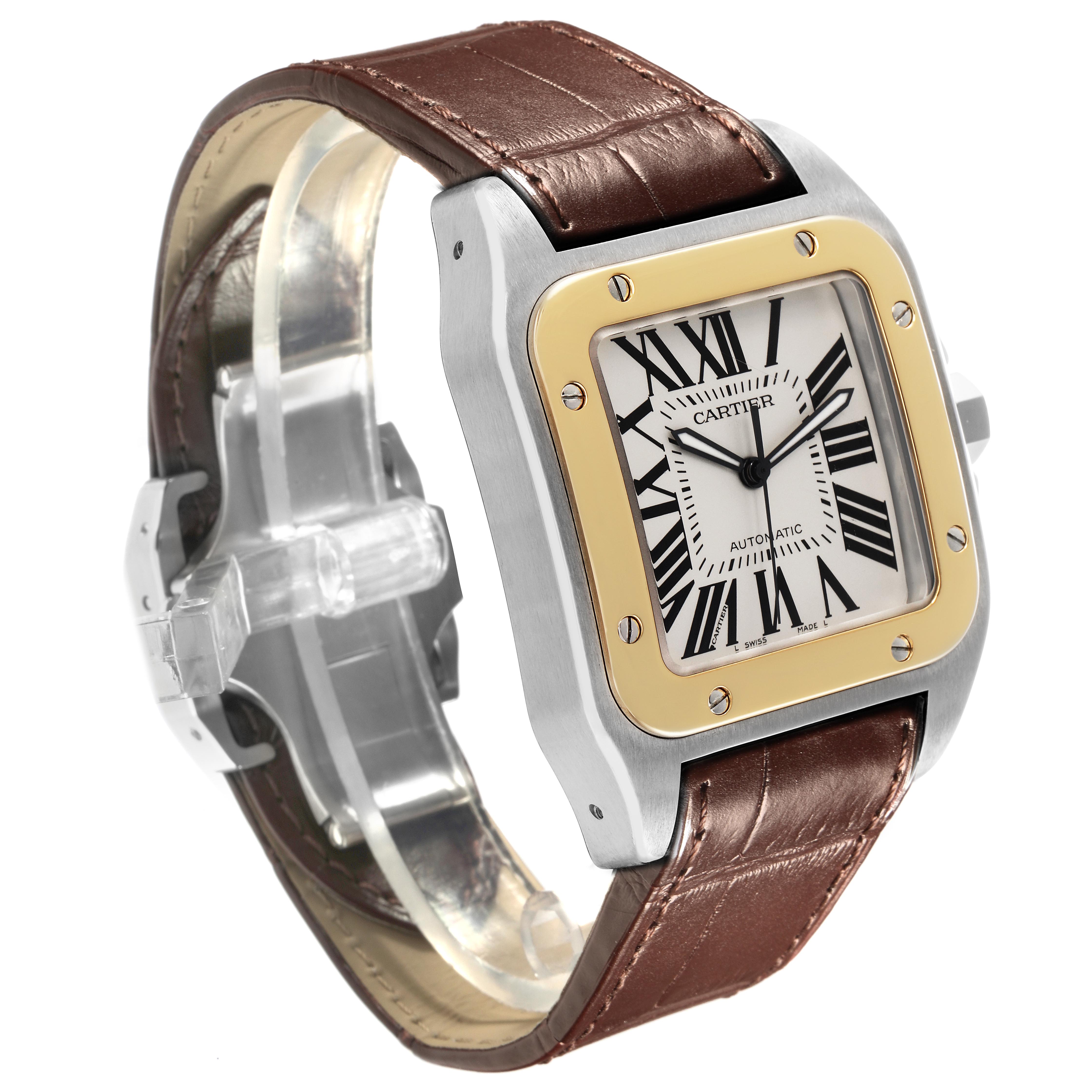 The Cartier Santos W20072X7 Men's Steel and Gold (two tone) Silver Dial W20072X7 Men's Steel and Gold (two tone) Silver Dial watch is shown at a three-quarter angle, highlighting its square face, gold bezel, brown leather strap, and Roman numerals.