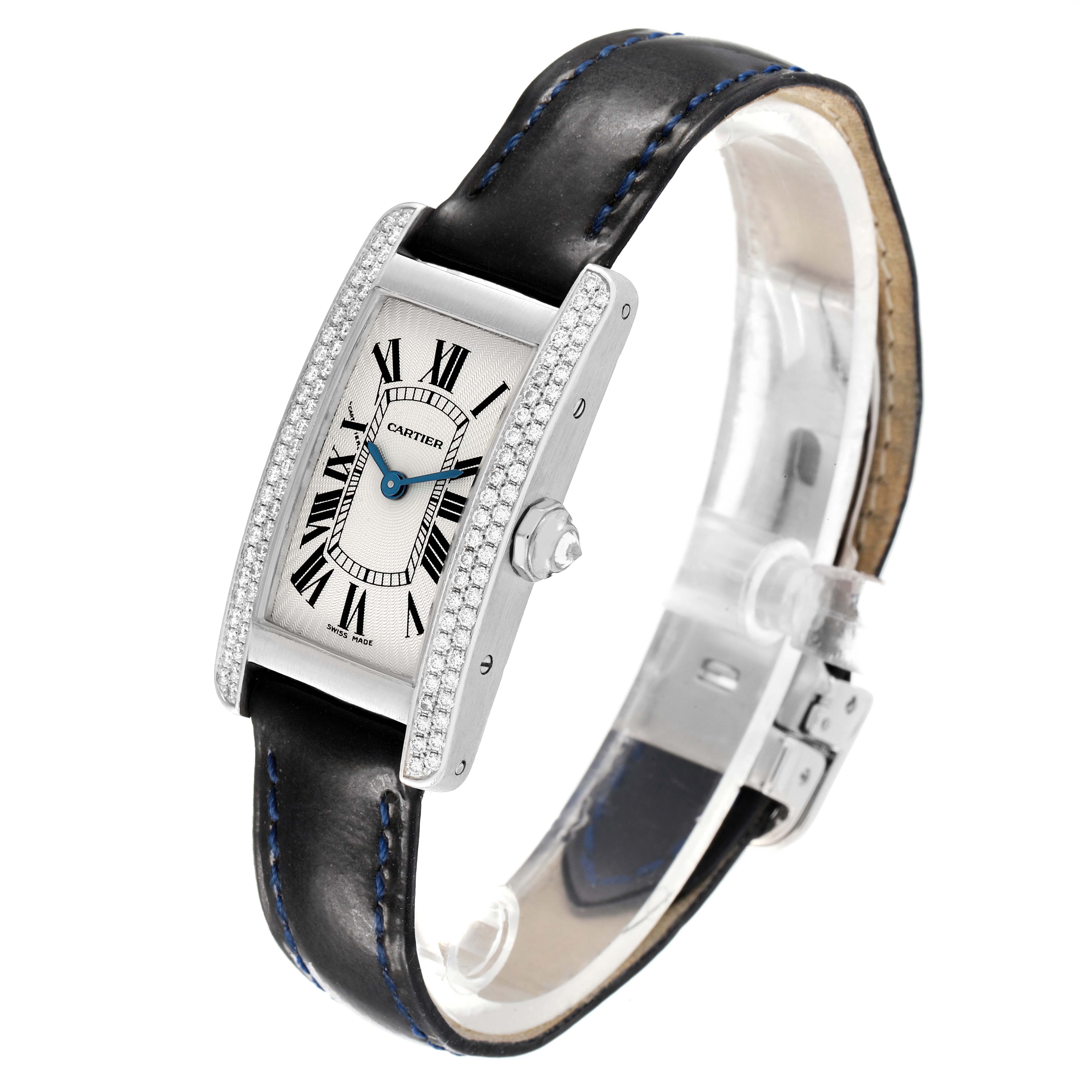 The Cartier Tank Americaine WB701851 Women's White Gold Silver Dial watch is shown at a three-quarter angle, displaying the face, rectangular case, and black leather strap.