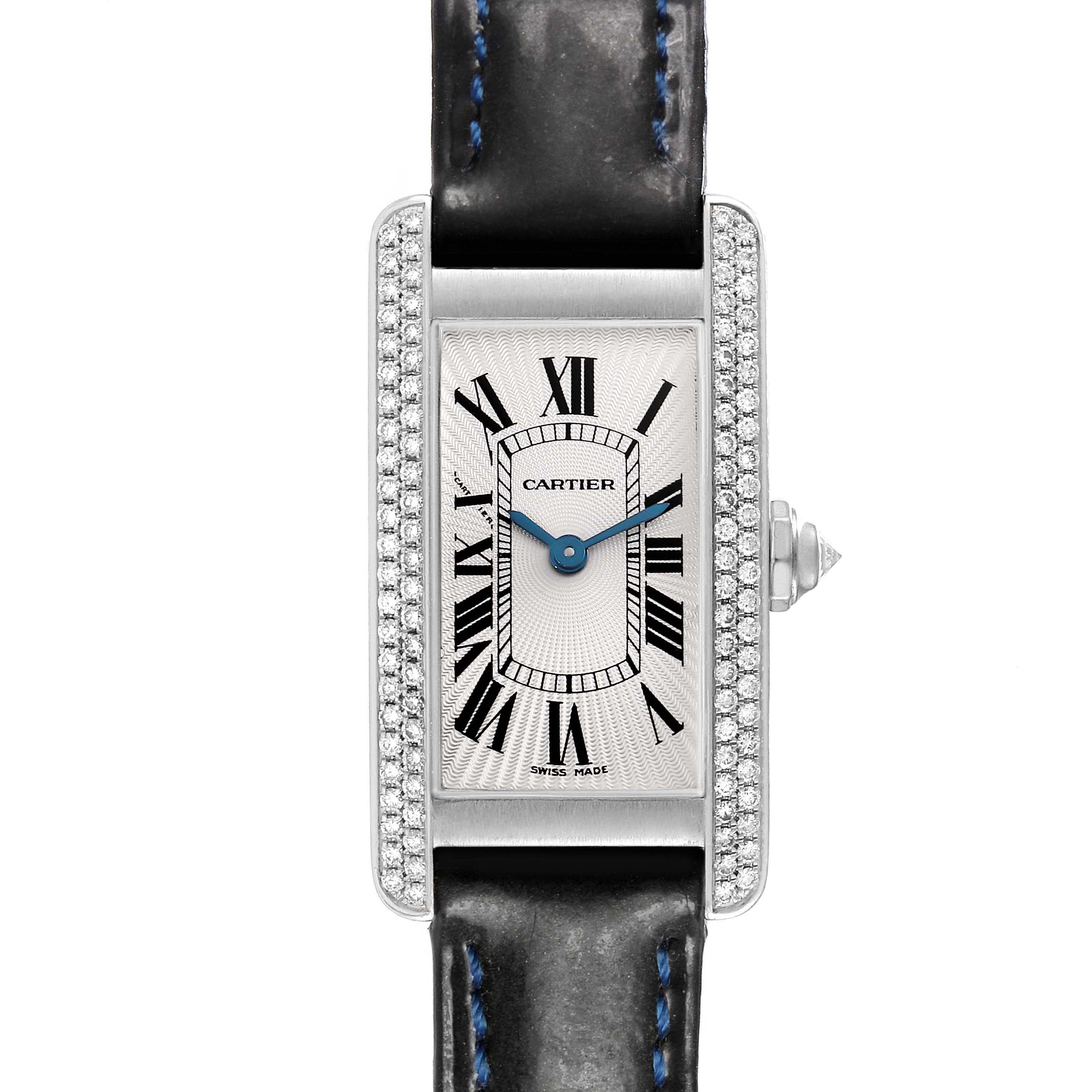 The Cartier Tank Americaine WB701851 Women's White Gold Silver Dial watch is shown from a front angle, featuring the rectangular face, Roman numerals, diamond-set bezel, and leather strap.