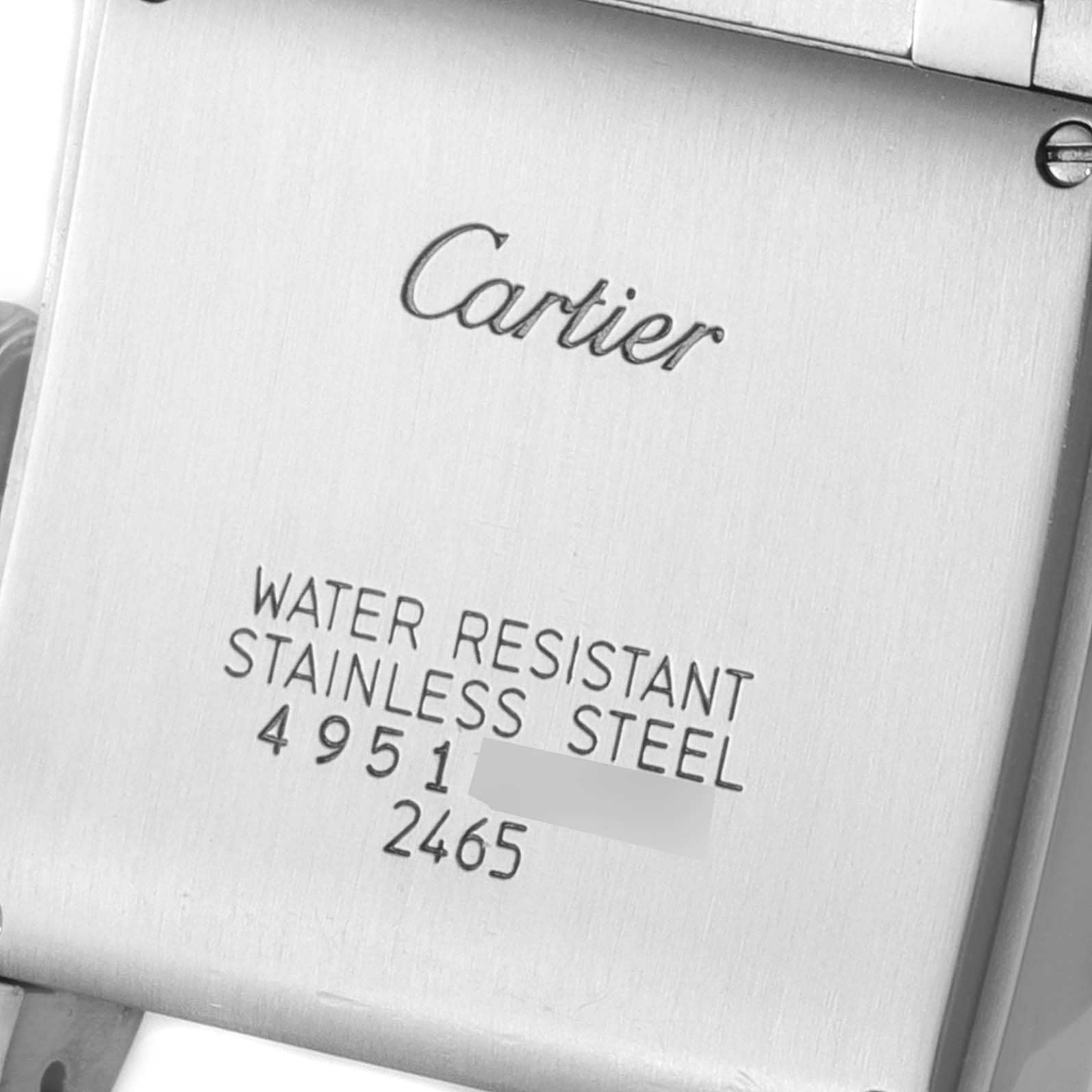 The image shows the back case of a Tank Française model by Cartier, highlighting the brand's logo and water resistance information.