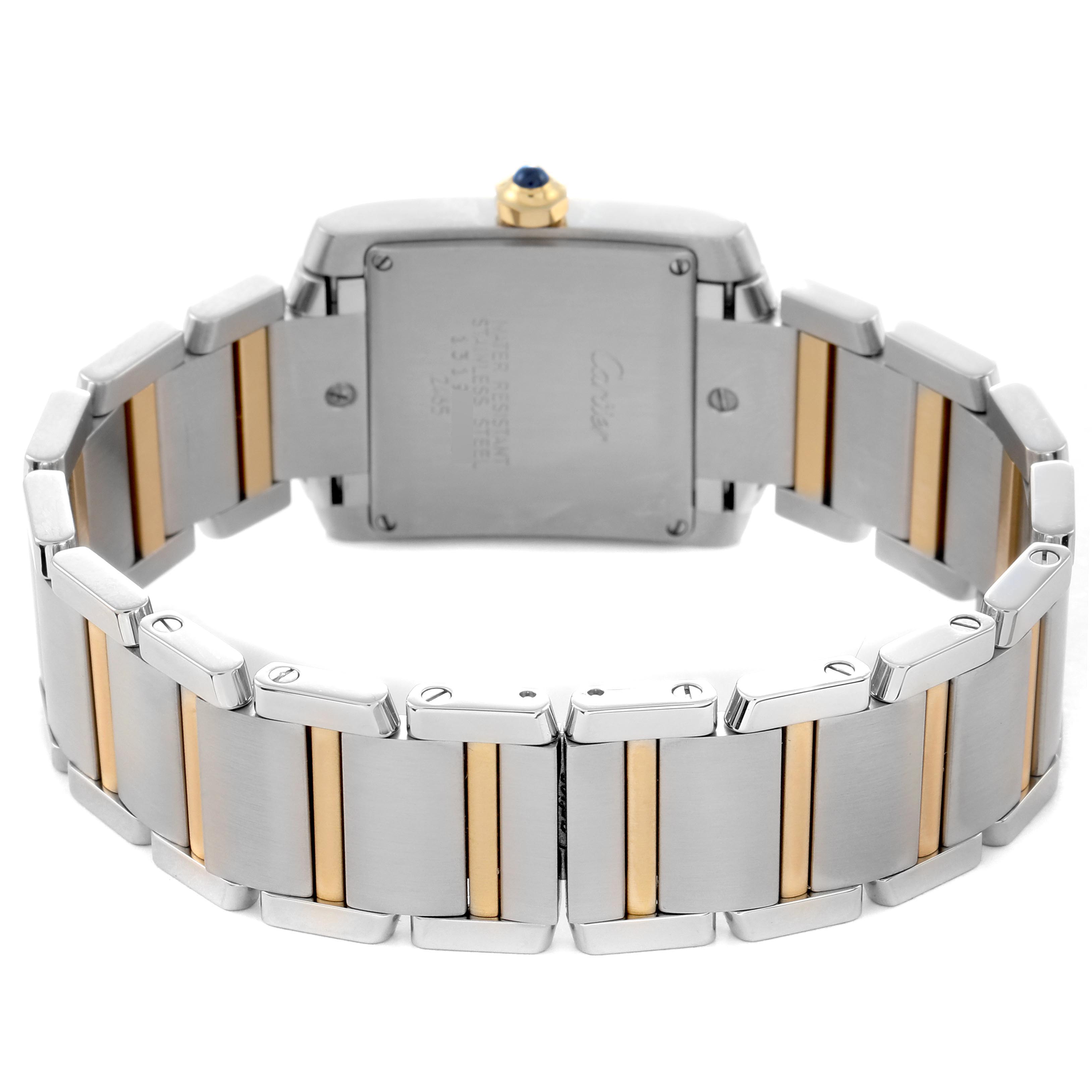 The Cartier Tank Française watch is shown from the back, displaying the case, crown, and two-tone bracelet.