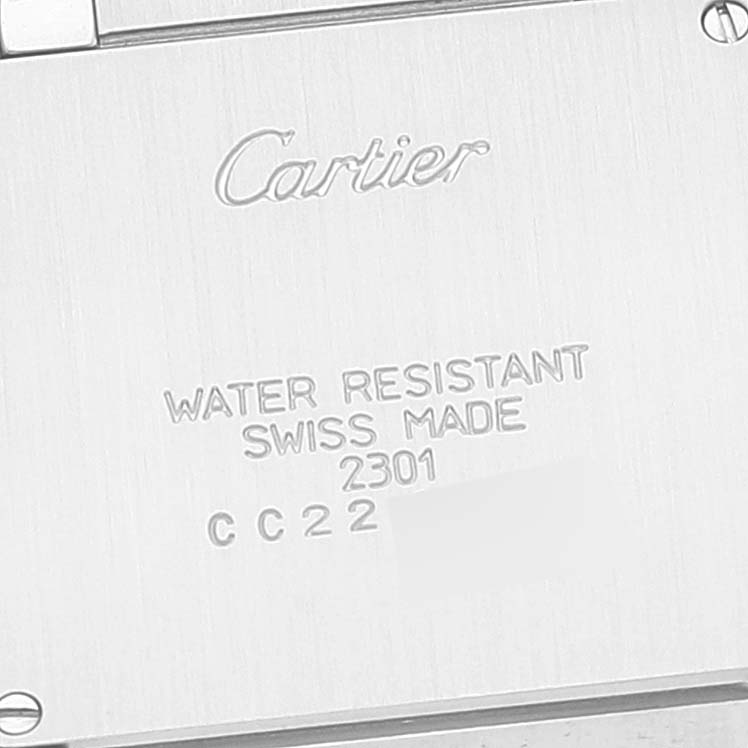 The image shows the back case of a Cartier Tank Francaise W2TA0003 Women's Steel and Gold (two tone) Silver Dial W2TA0003 Women's Steel and Gold (two tone) Silver Dial watch with engraved details about water resistance and manufacturing.