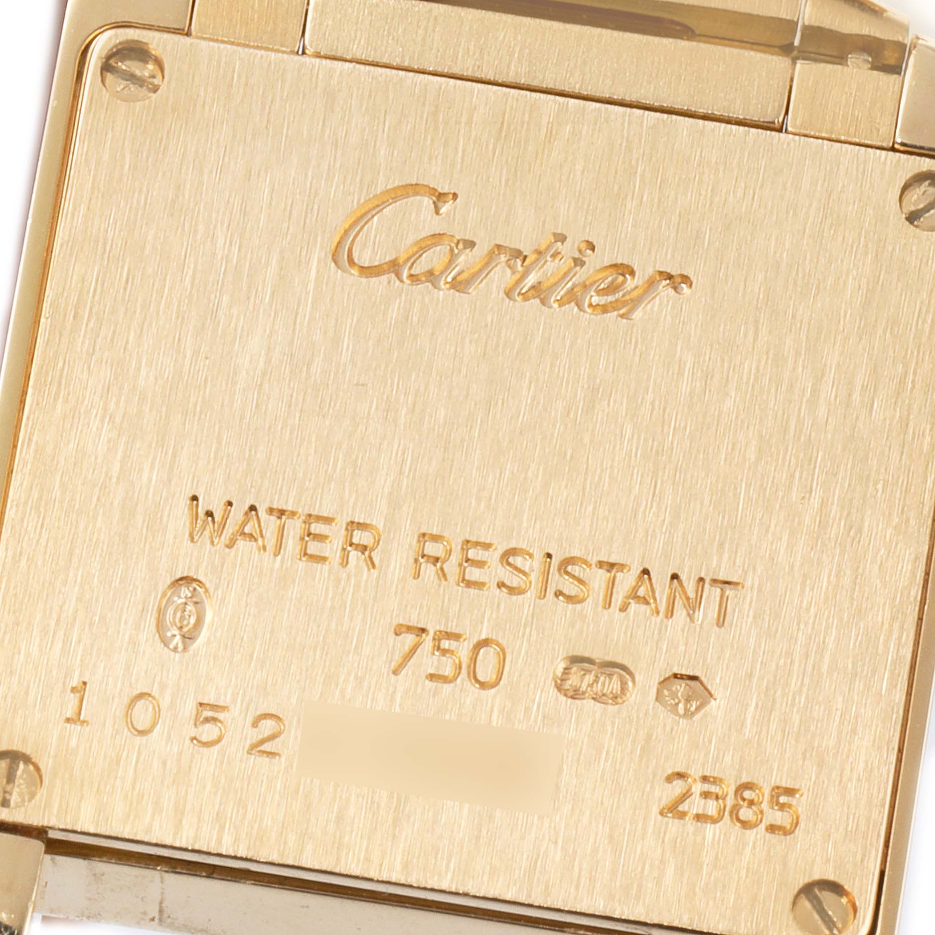 The image shows the case back of a Cartier Tank Française watch inscribed with the brand, model, and specifications.