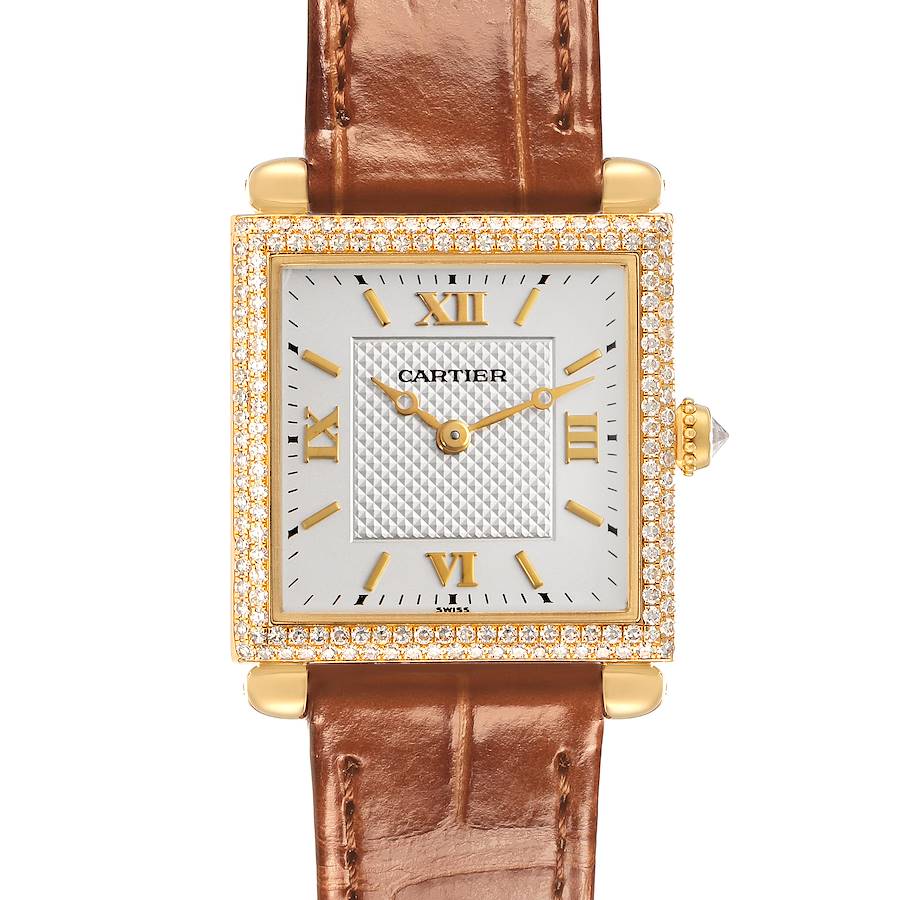The Cartier Tank Obus watch is shown front-facing, highlighting its square face, leather strap, gold Roman numerals, and diamond bezel.