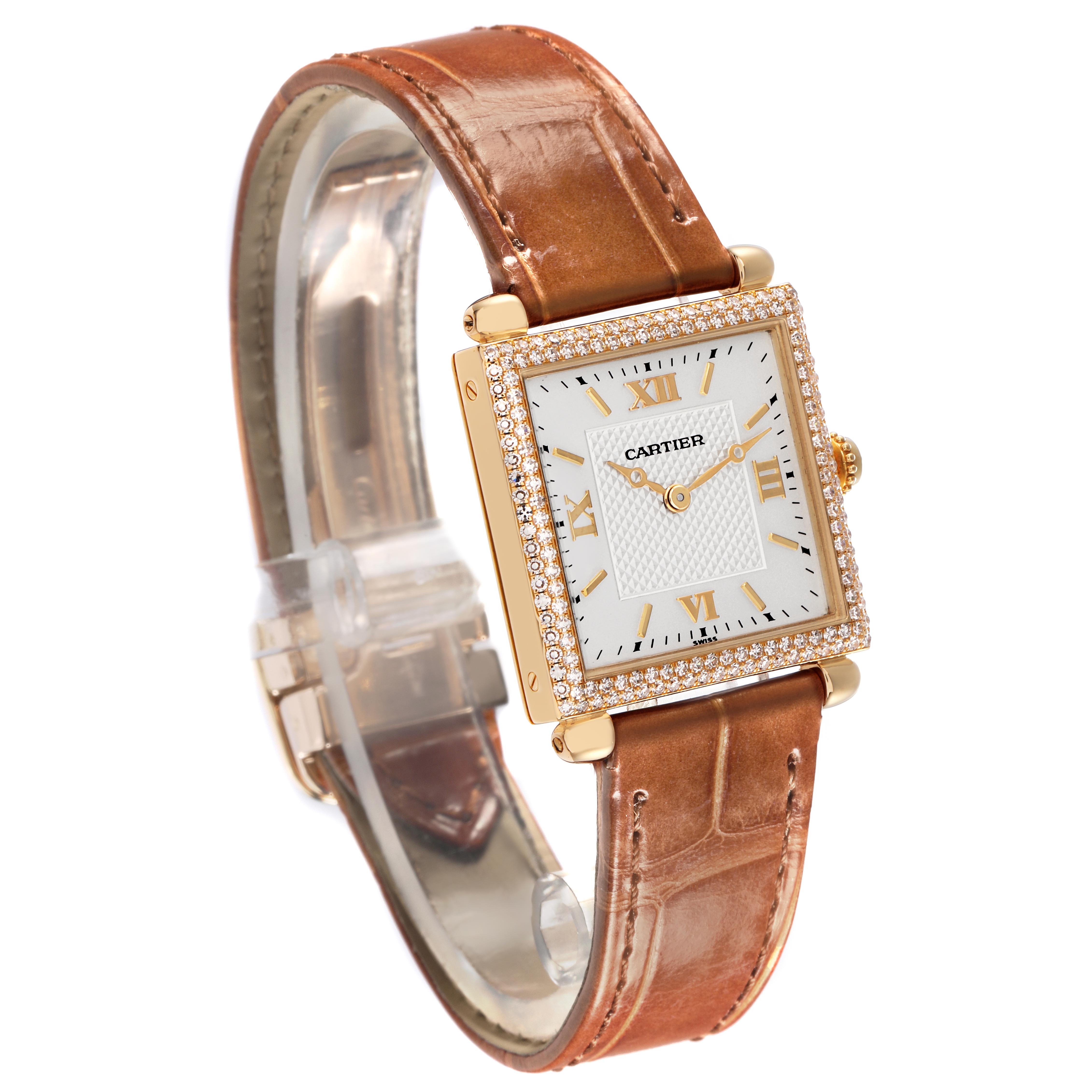 The Cartier Tank Obus WB800351 Women
s Yellow Gold Silver Dial WB800351 Women
s Yellow Gold Silver Dial watch is shown at a slight angle, displaying its face, bezel, and brown leather strap.