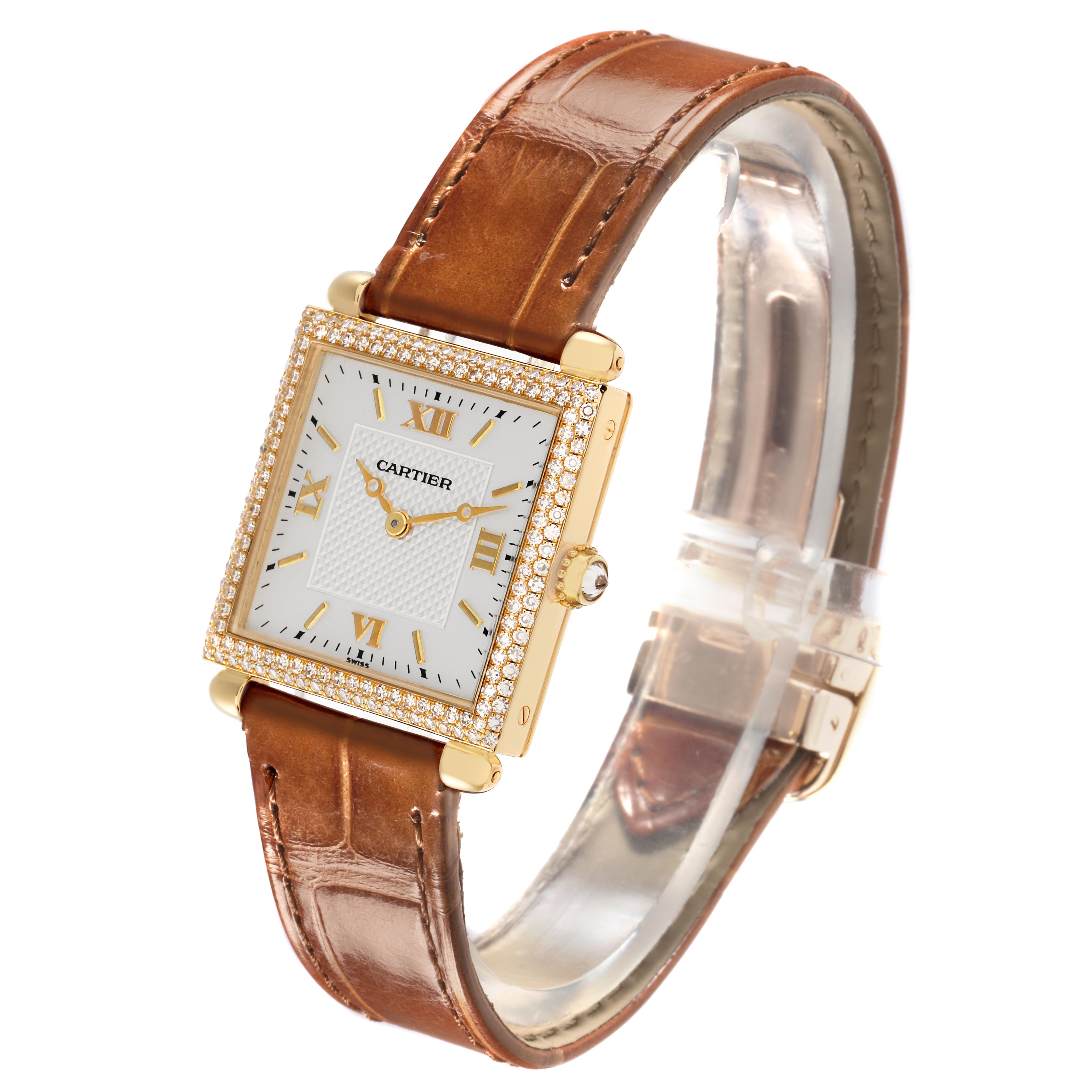 The Cartier Tank Obus WB800351 Women
s Yellow Gold Silver Dial WB800351 Women
s Yellow Gold Silver Dial watch is shown at a three-quarter angle, highlighting its square case, leather strap, and diamond bezel.