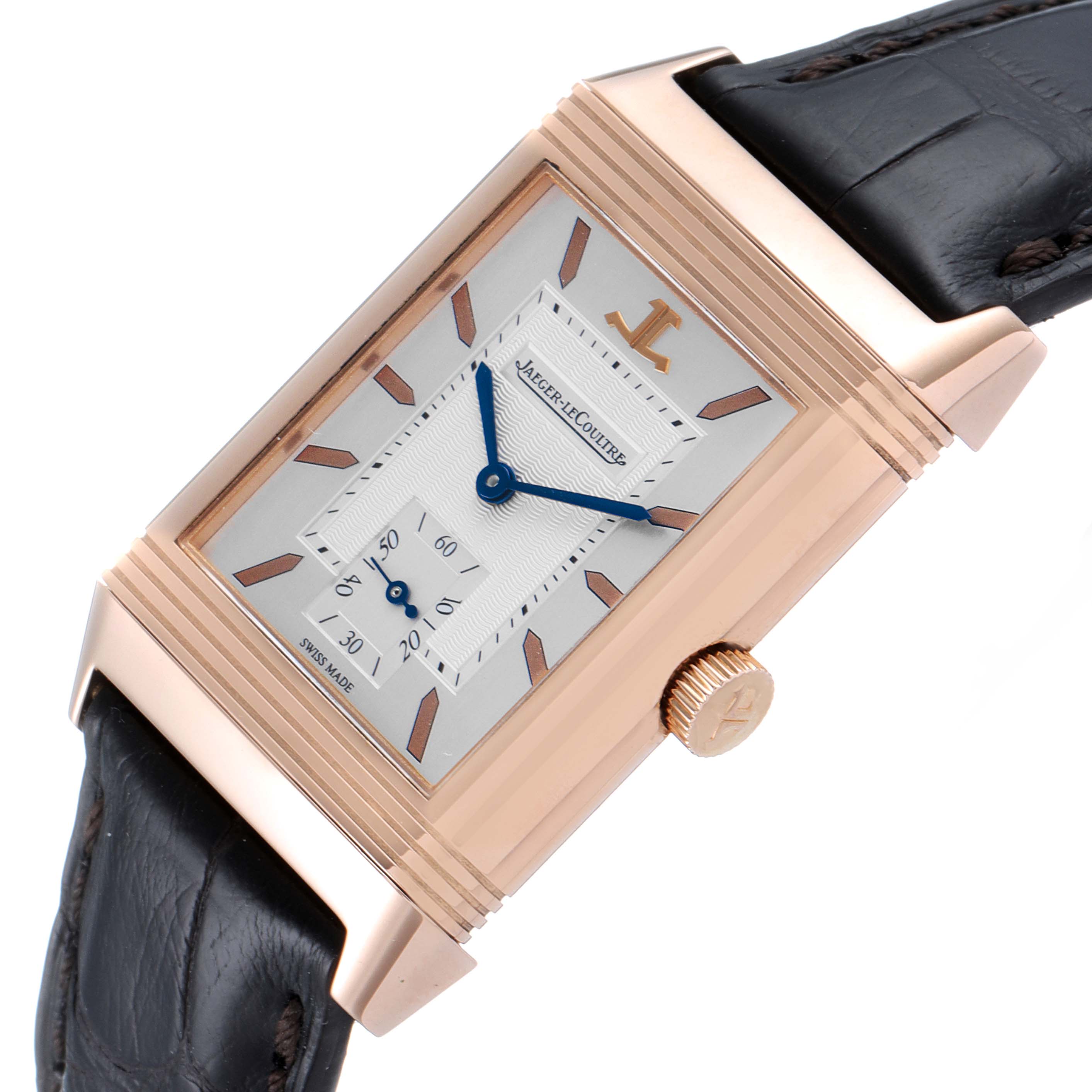 The image shows a Jaeger-LeCoultre Reverso watch in a gold casing with a leather strap, viewed from an angled side profile.