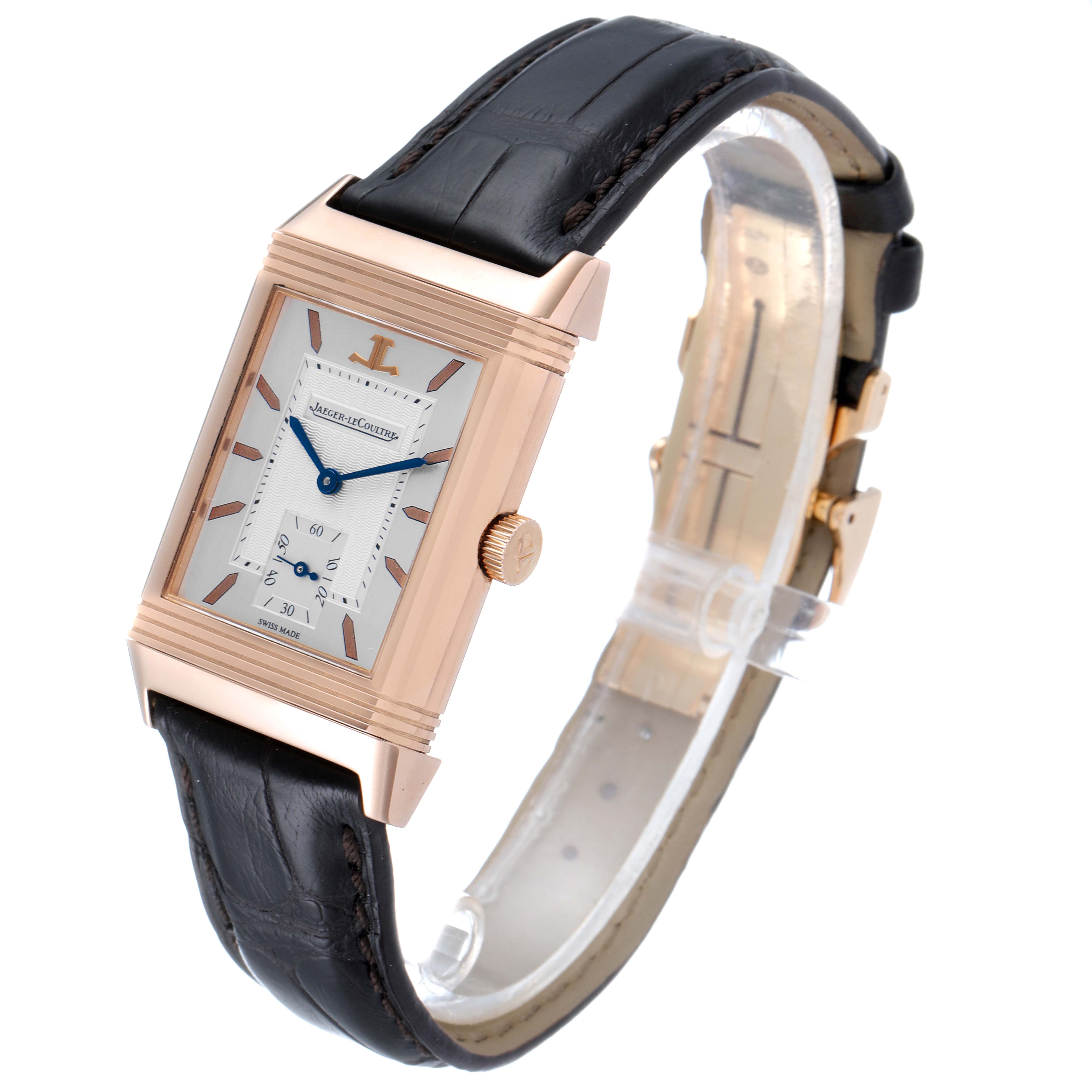 The image shows a Jaeger LeCoultre Reverso Q270262 Men's Rose Gold Silver Dial Q270262 Men's Rose Gold Silver Dial watch from an angled side view, highlighting the rectangular face, crown, and black leather strap.