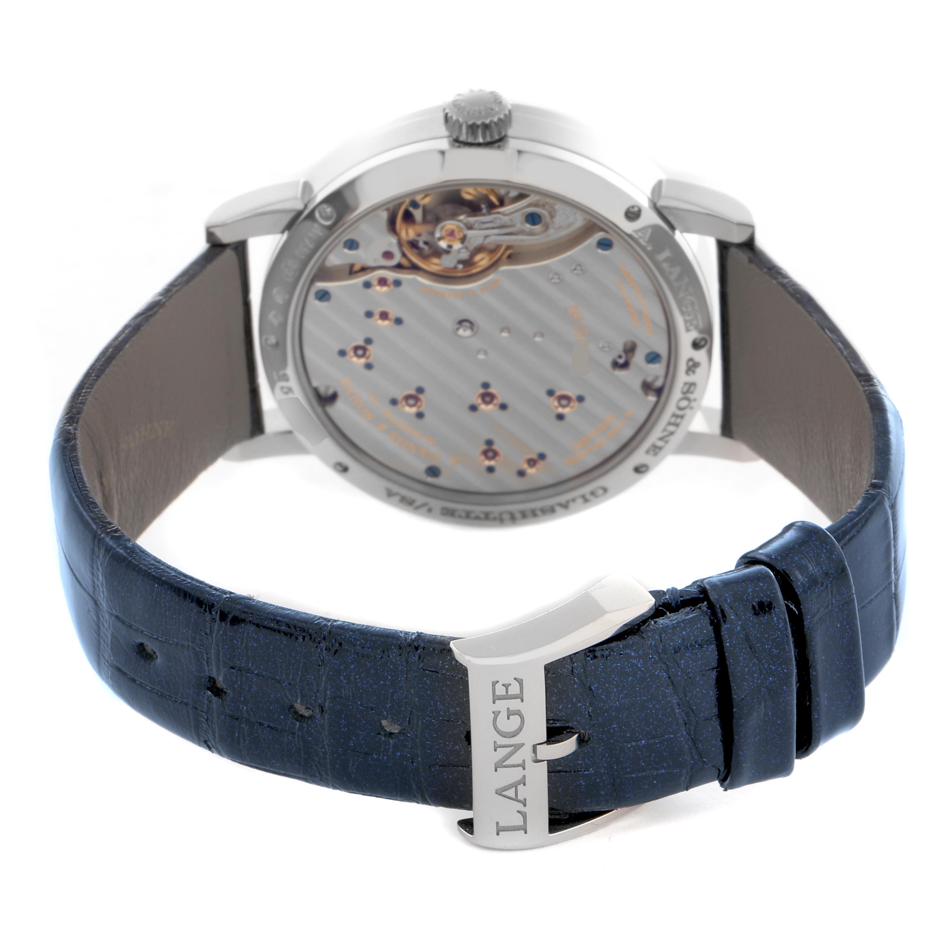 The image shows the A. Lange 
Sohne Lange 1 182.086/LSLS823AX Men
s White Gold Blue Dial watch
s case back, revealing the movement, along with part of the strap and buckle.