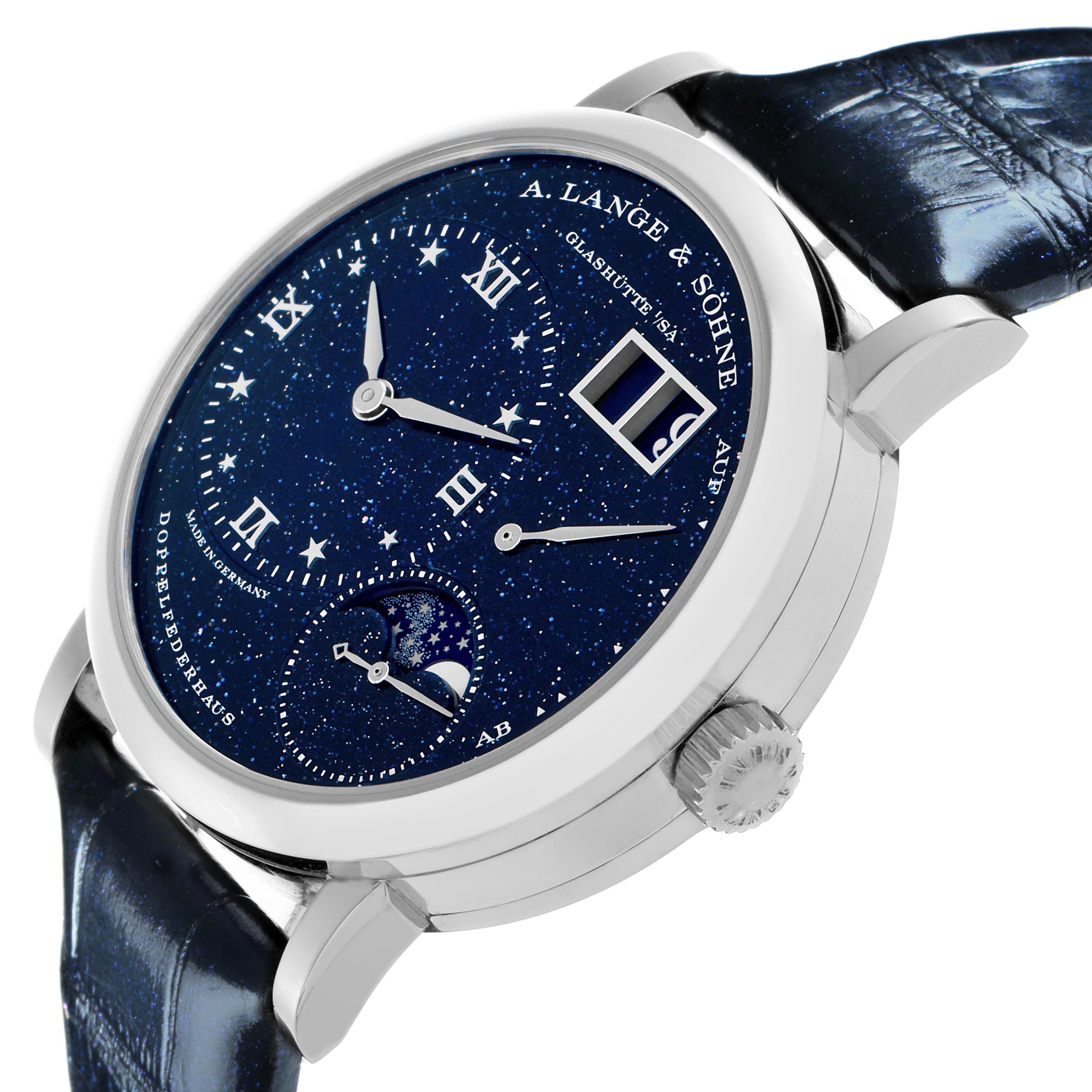 The A. Lange 
Sohne Lange 1 182.086/LSLS823AX Men
s White Gold Blue Dial watch is shown from a slightly tilted front angle, highlighting the dial, hands, and crown.
